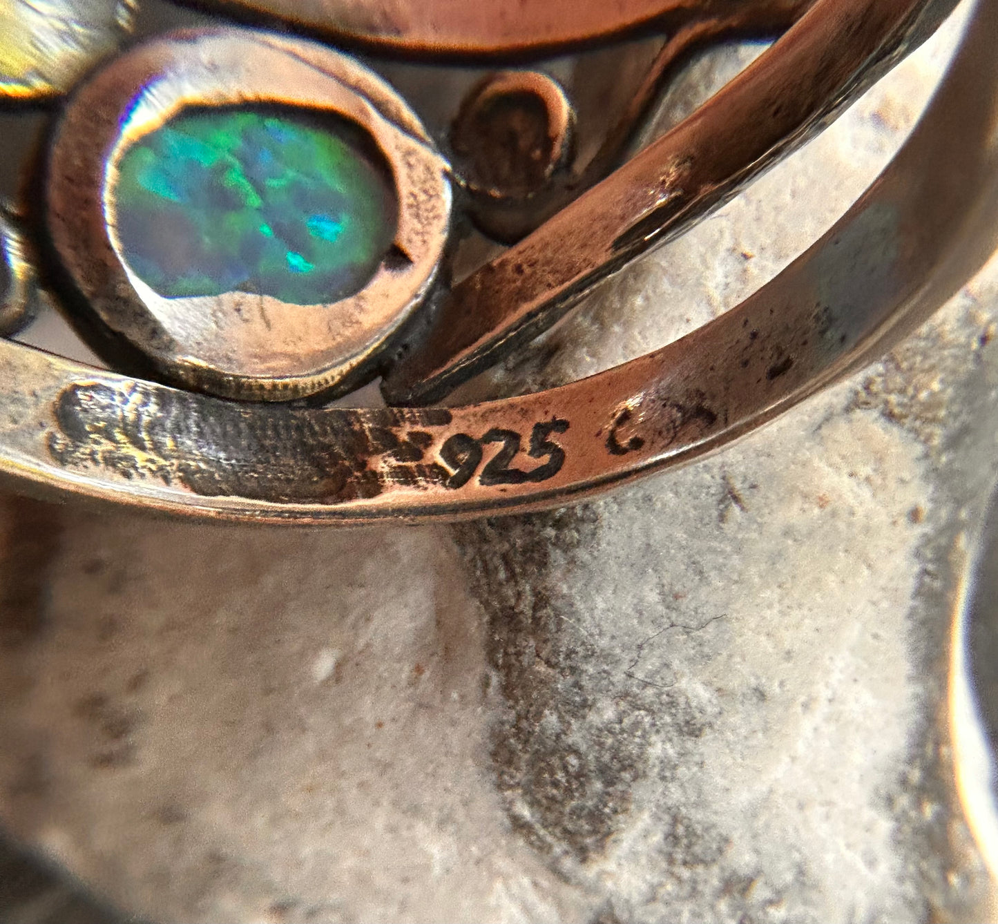 Vintage sterling silver artisan ring featuring a captivating lab-created opal