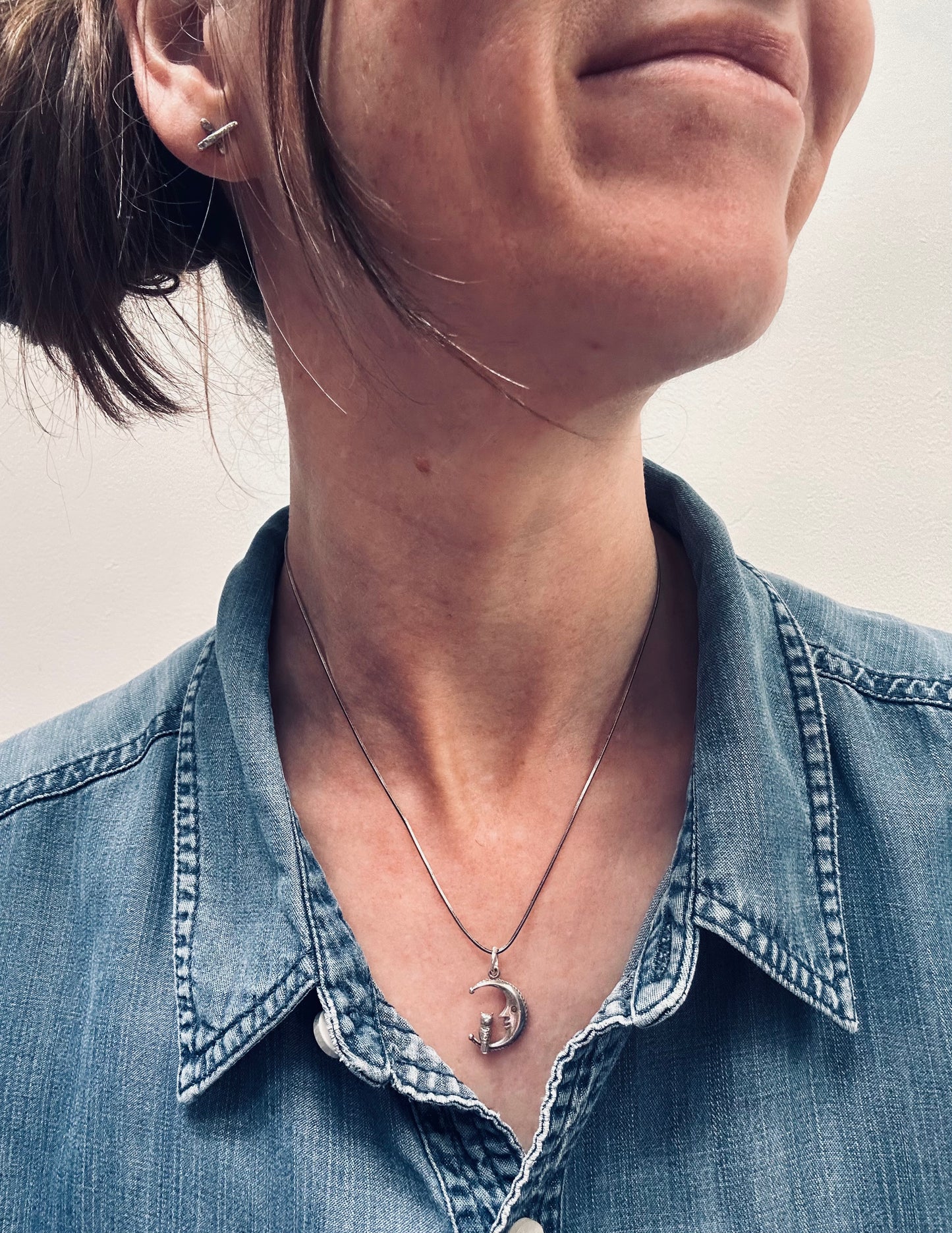 A beautifully whimsical vintage moon and owl pendant