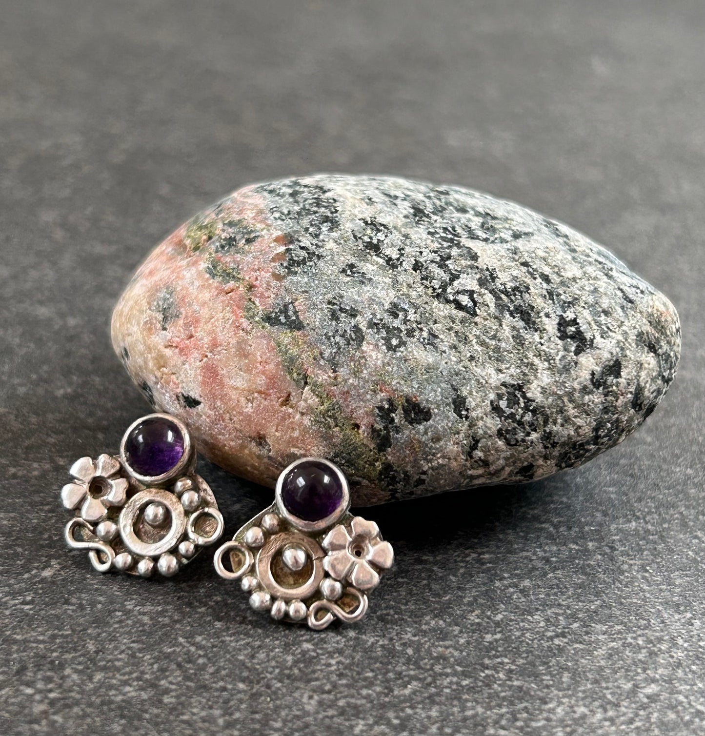 Beautiful sterling silver stud earrings set with cabochon-cut amethysts.