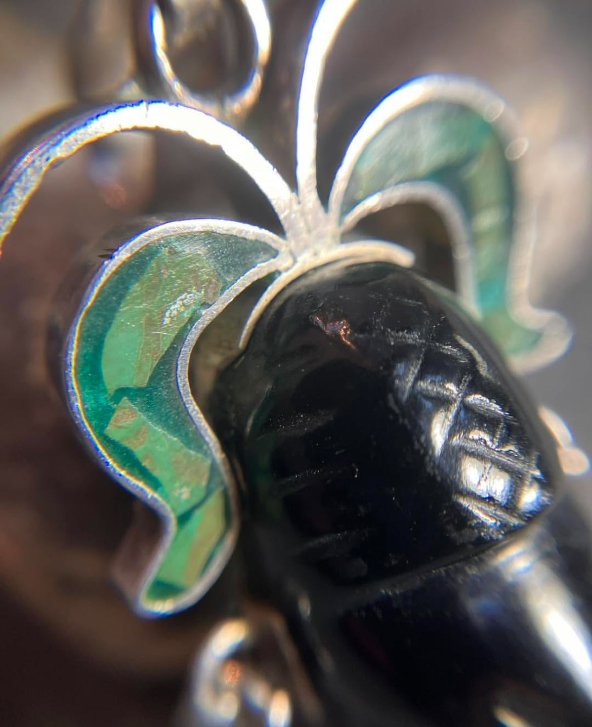 A striking vintage Mexican warrior face pendant crafted in sterling silver.