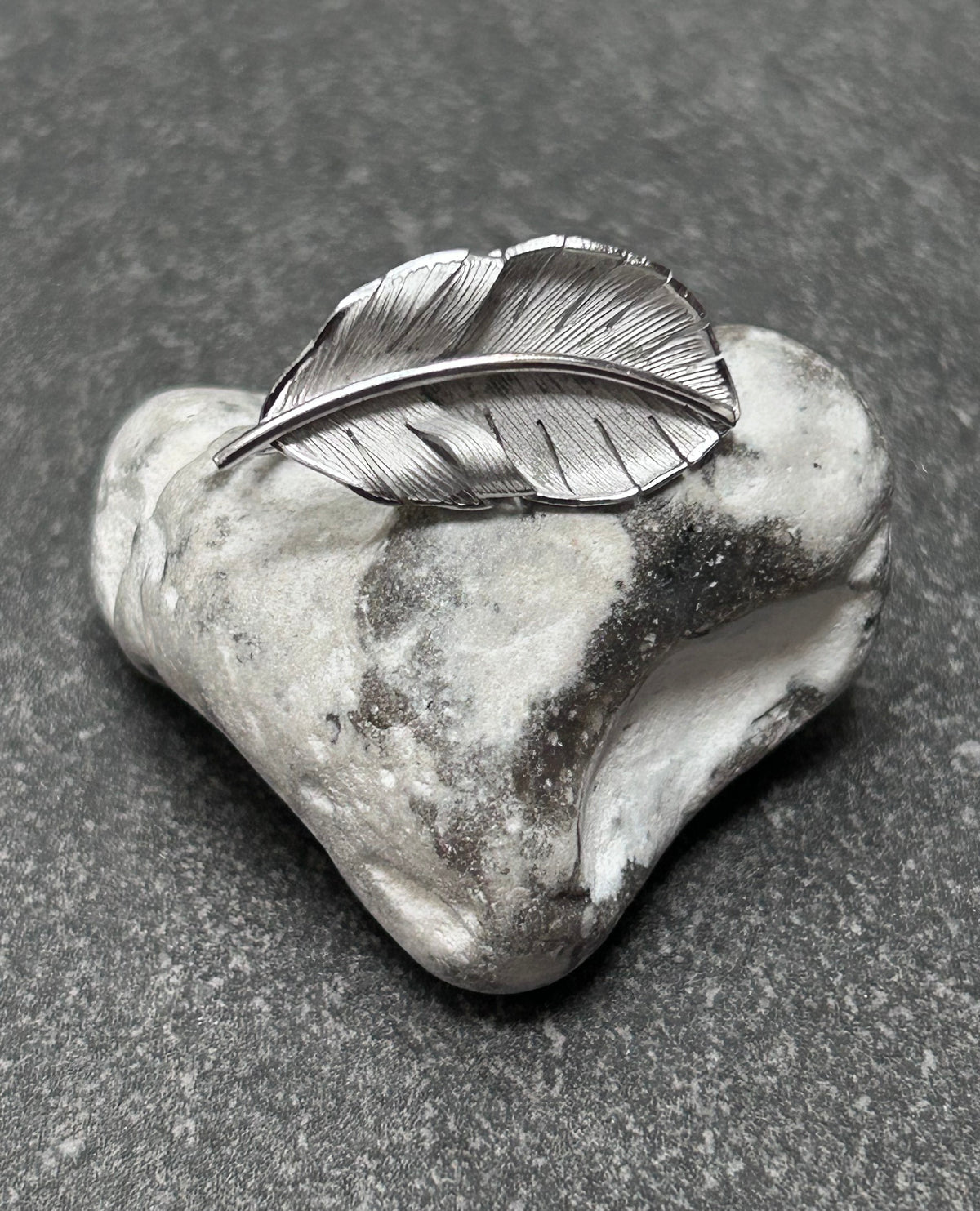 A beautiful pair of vintage screw on sterling silver feather earrings