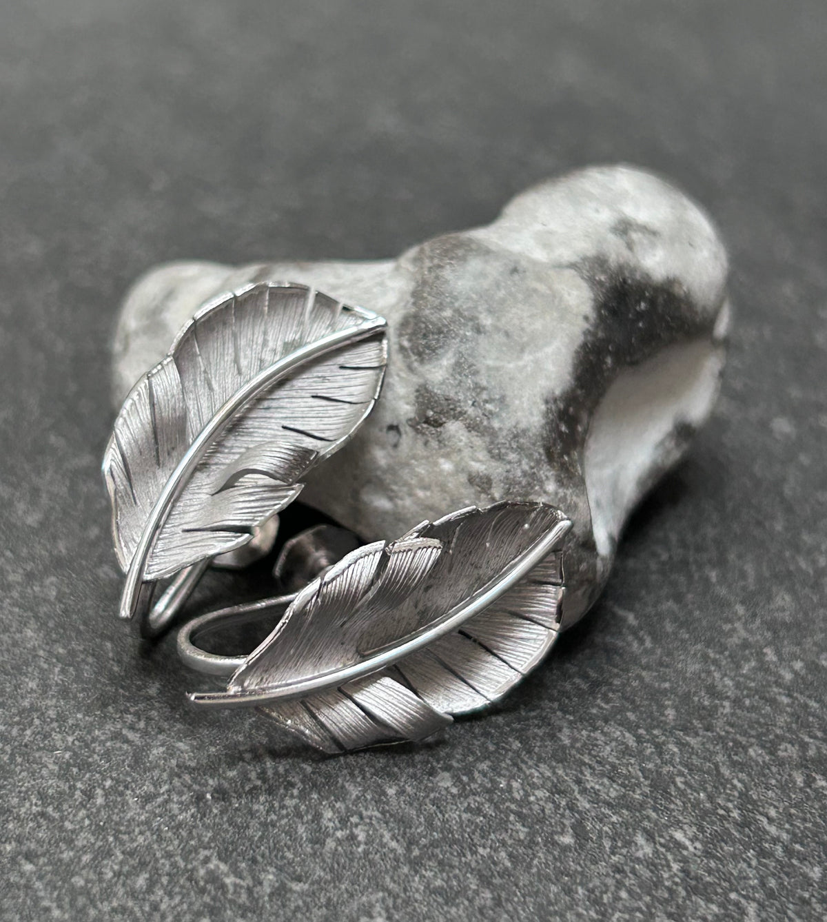 A beautiful pair of vintage screw on sterling silver feather earrings
