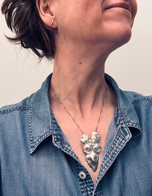 A rare sterling silver dogwood flower pendant from John Wanamaker.