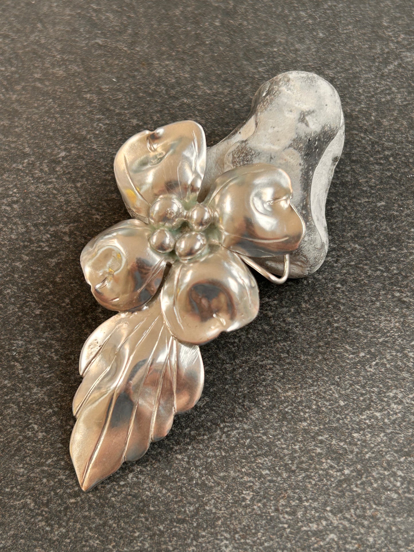 A rare sterling silver dogwood flower pendant from John Wanamaker.