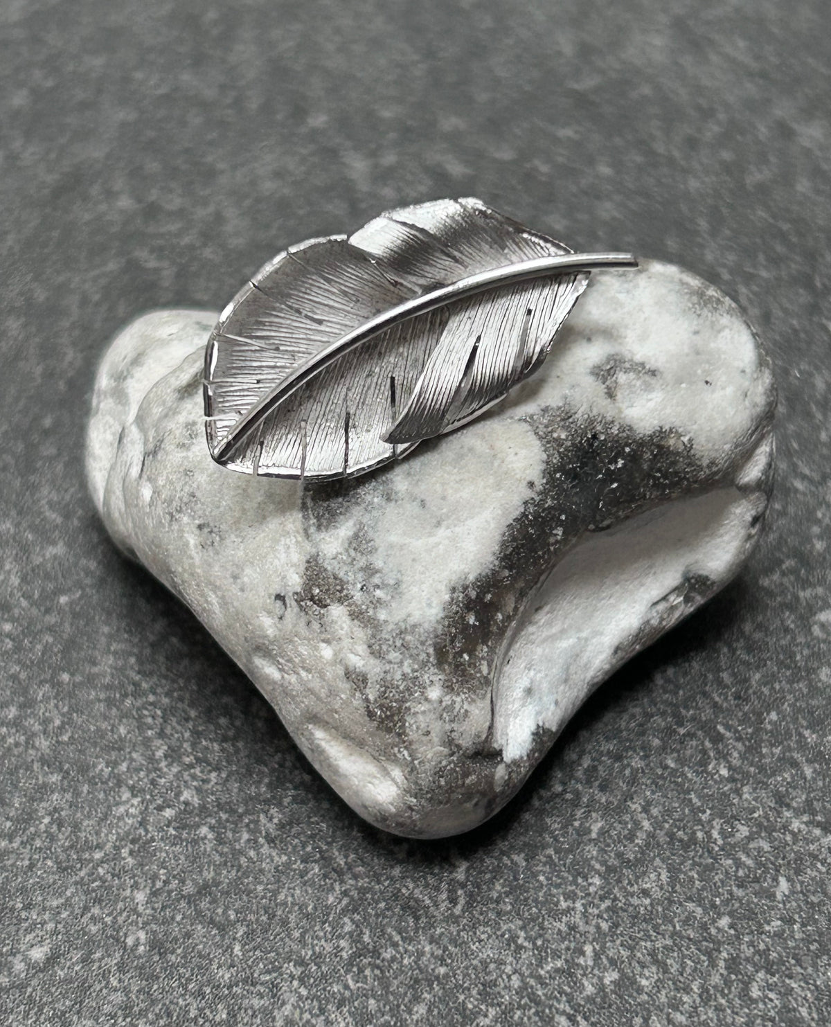 A beautiful pair of vintage screw on sterling silver feather earrings