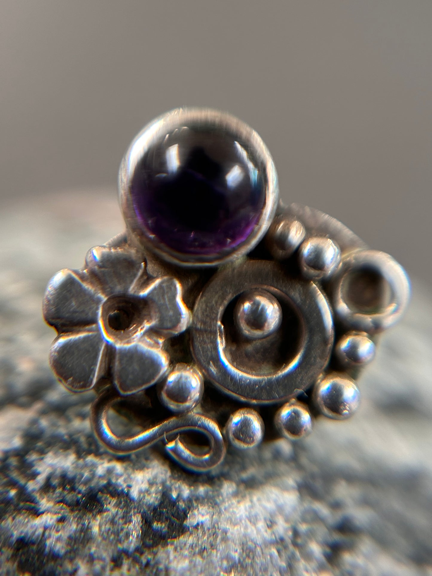 Beautiful sterling silver stud earrings set with cabochon-cut amethysts.