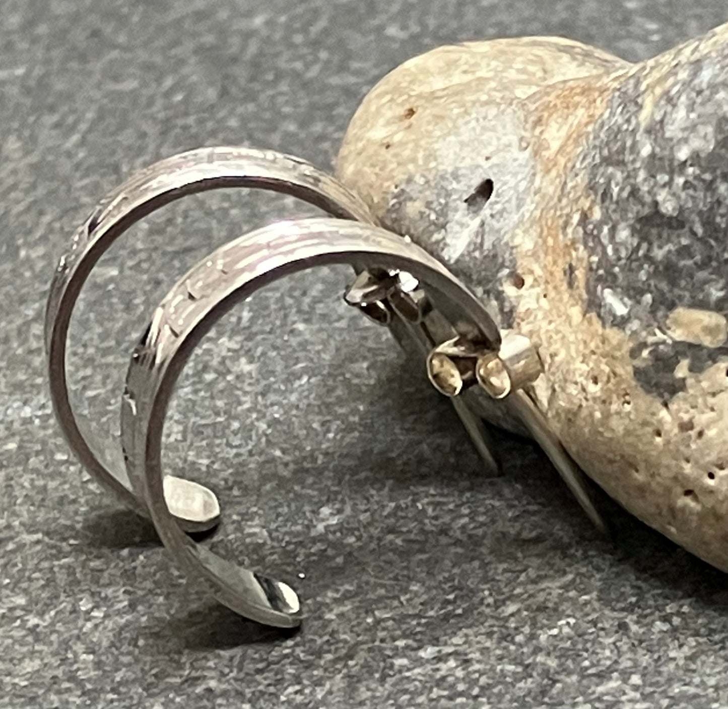 Vintage sterling silver hoops with all over intricate engraved pattern.