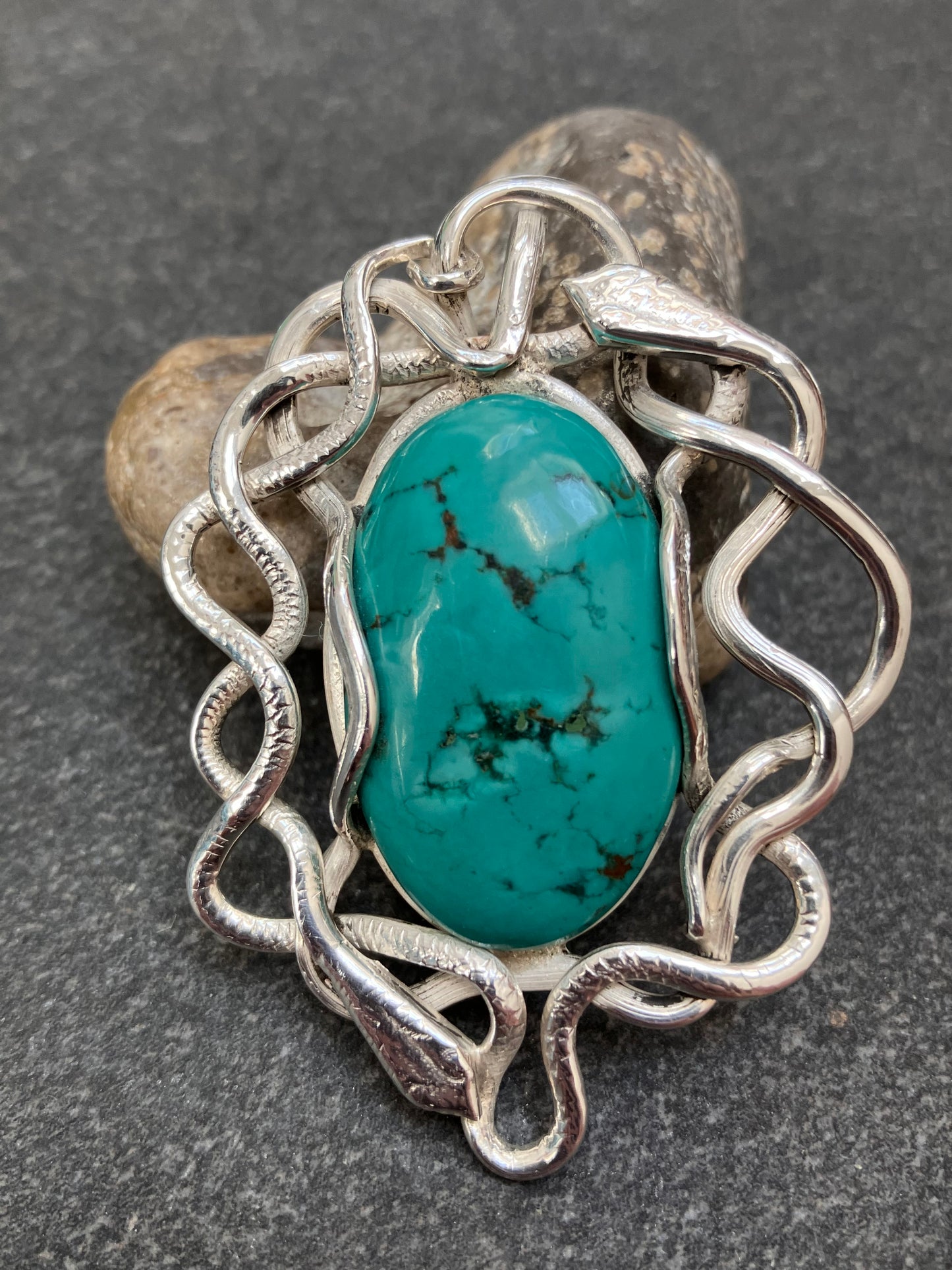 Artisan vintage sterling silver intertwining snake pendant with a piece of Turqurenite in the centre.