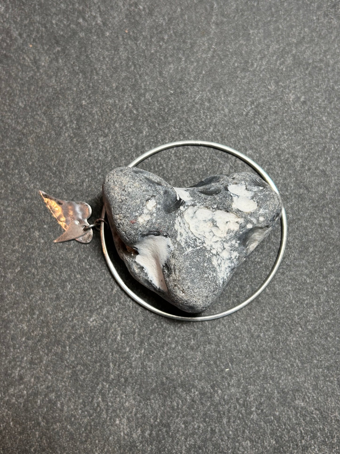 Delicate artisan bangle with two silver hearts.