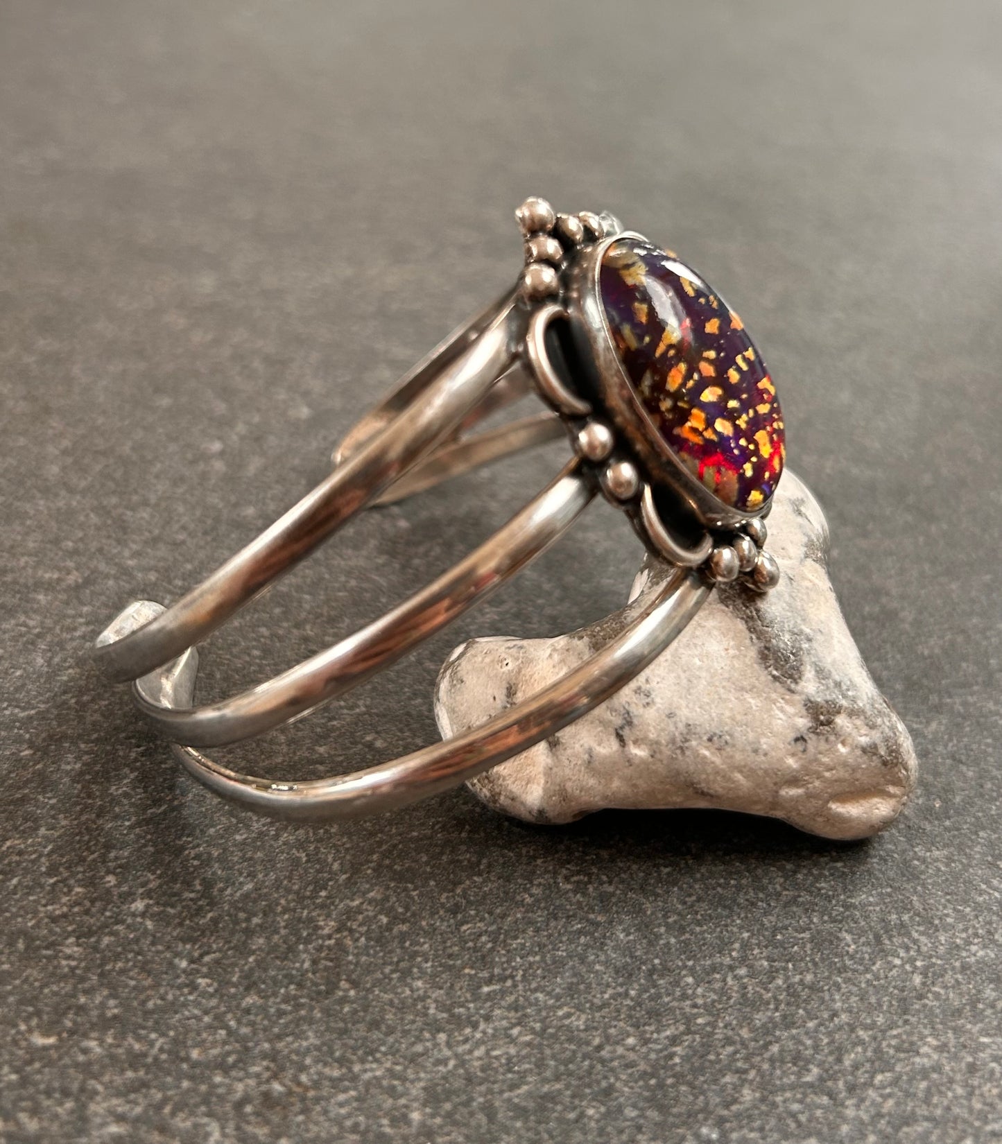 A striking vintage sterling silver bangle featuring a beautiful domed glass cabochon