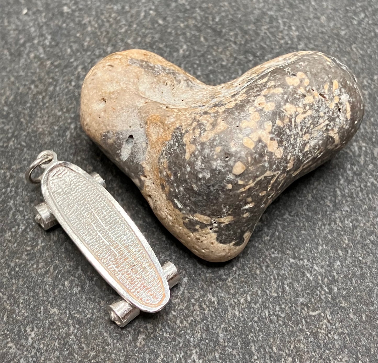 Vintage sterling silver skateboard pendant.