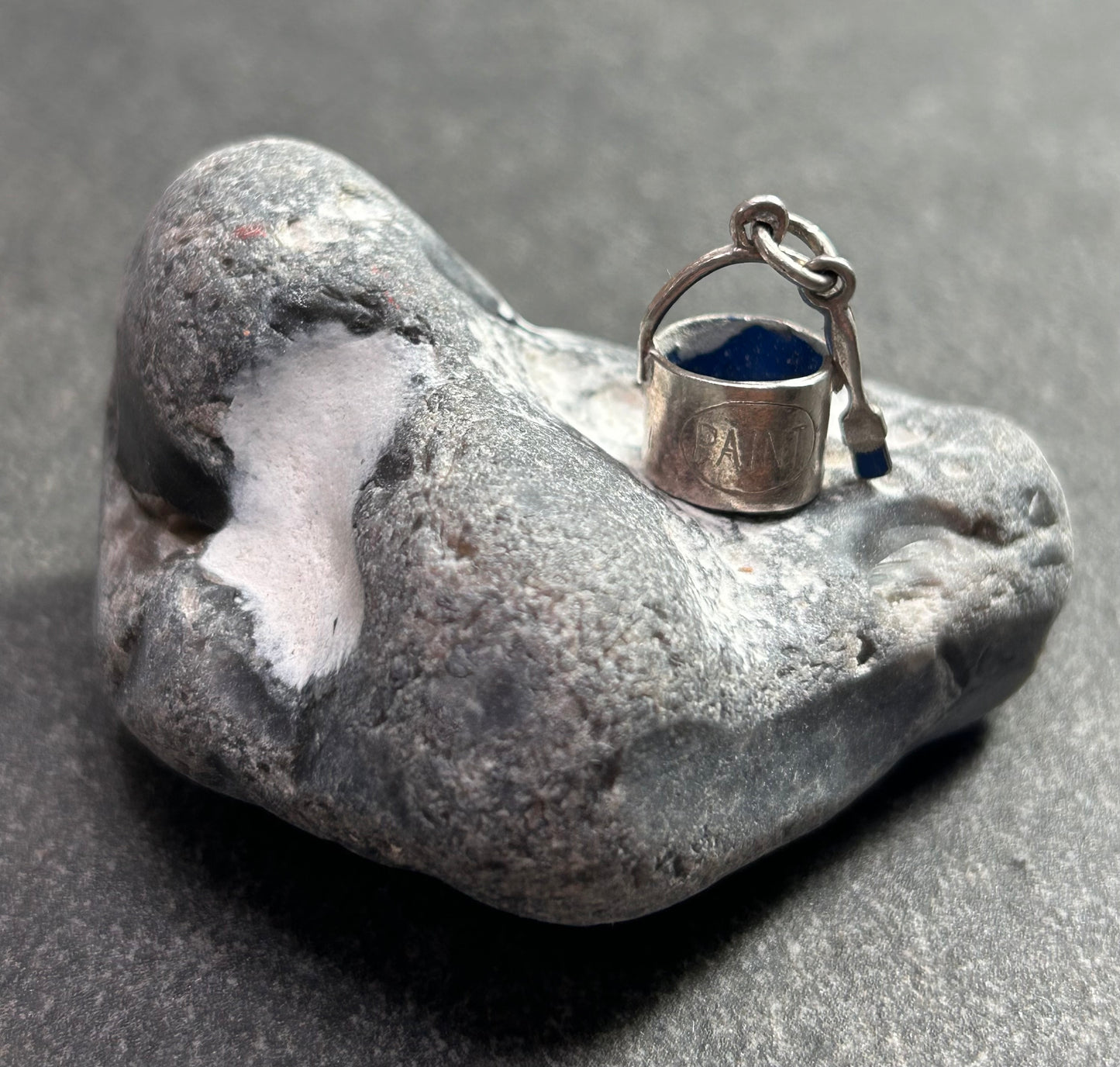 Pendant beautifully crafted in the shape of a painter’s paint pot and brush