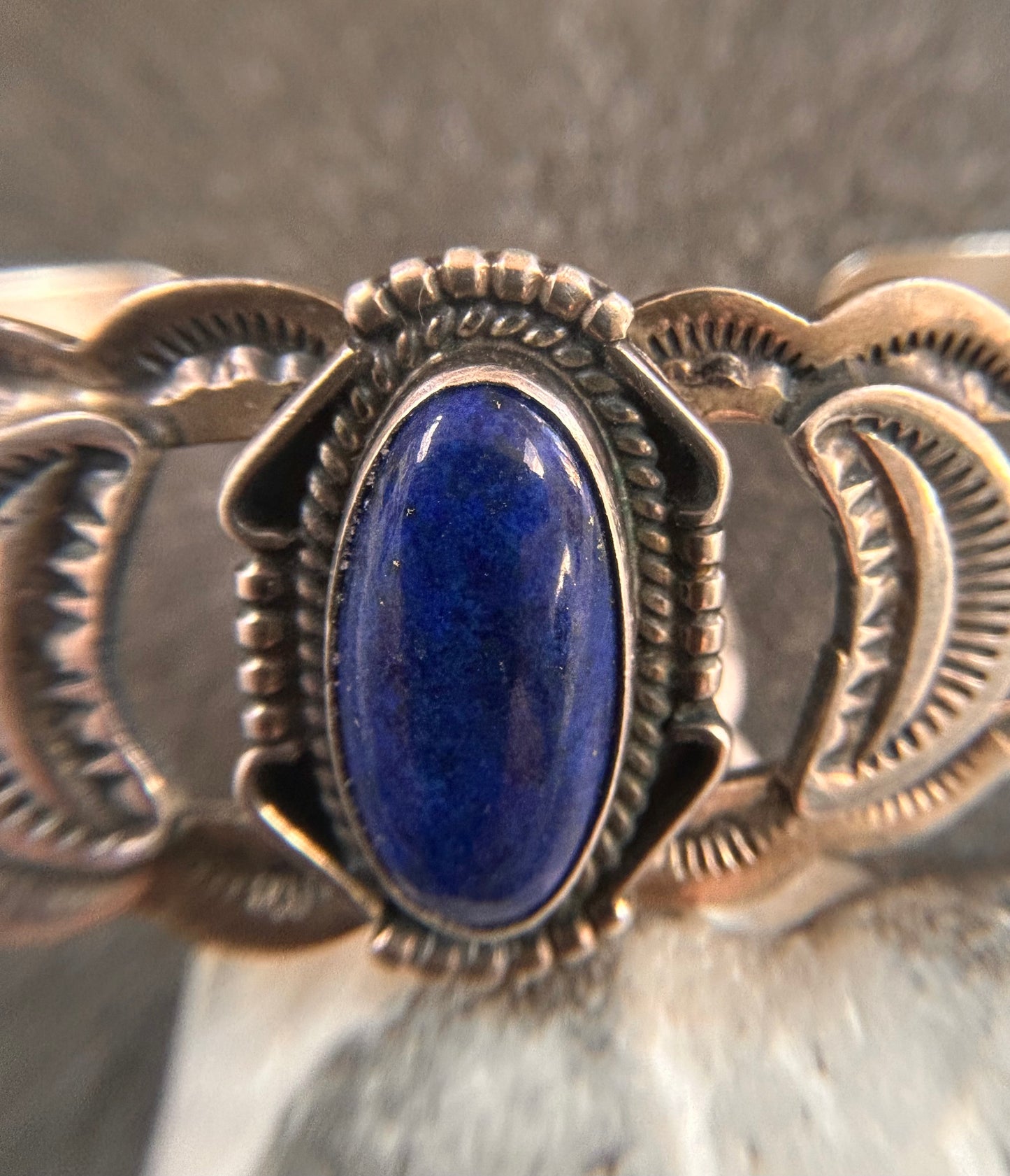 Vintage sterling silver Native American bangle featuring a striking central cabochon of lapis lazuli