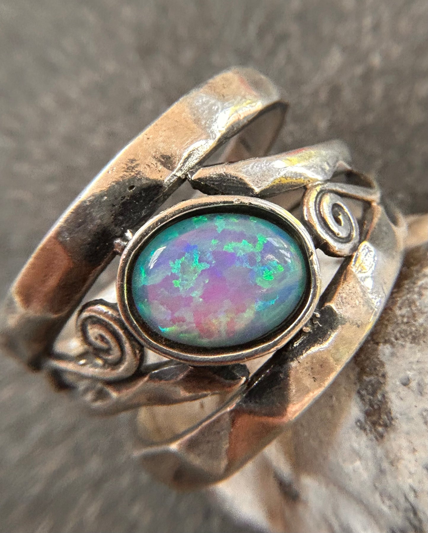 Vintage sterling silver artisan ring featuring a captivating lab-created opal