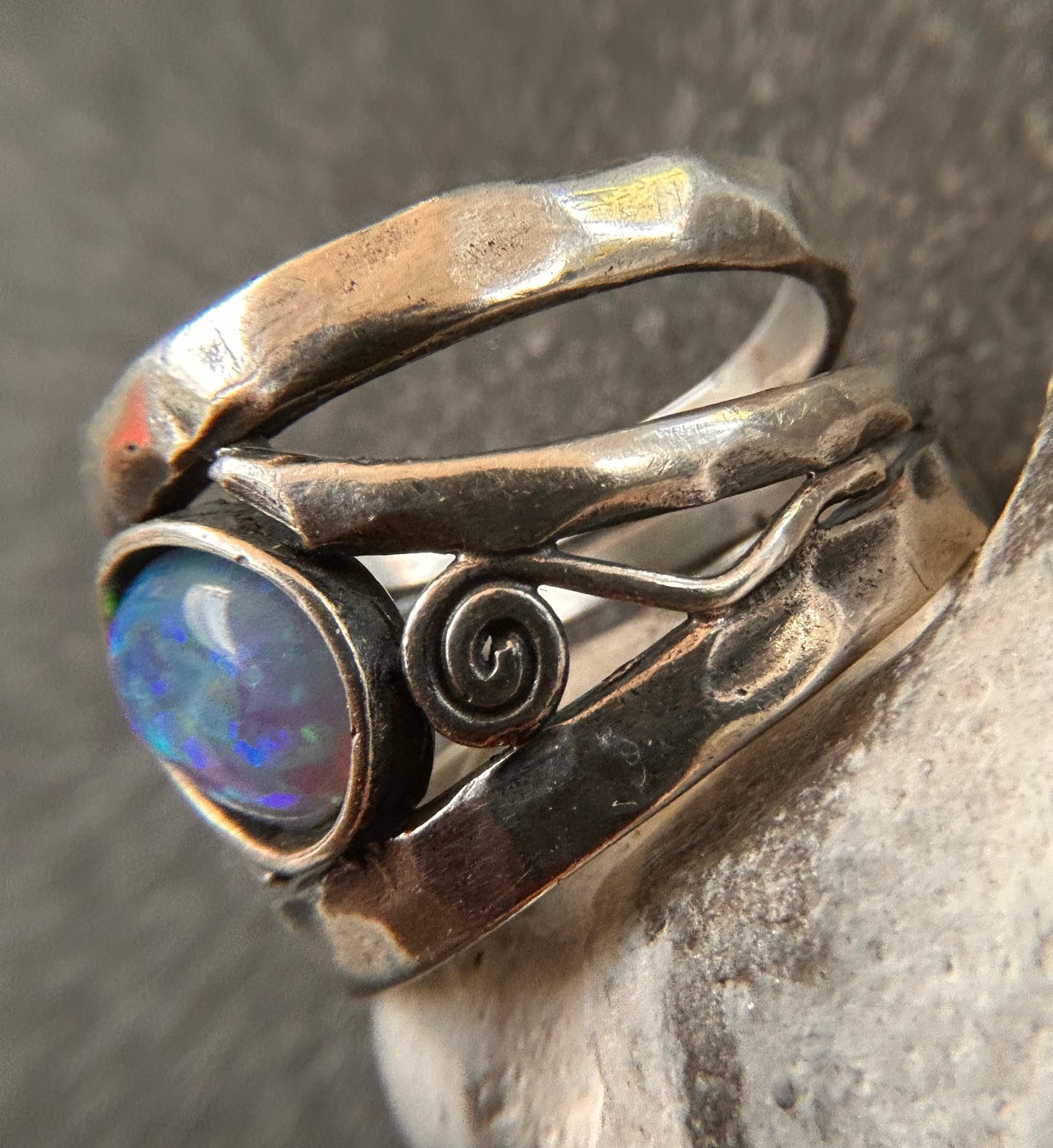Vintage sterling silver artisan ring featuring a captivating lab-created opal