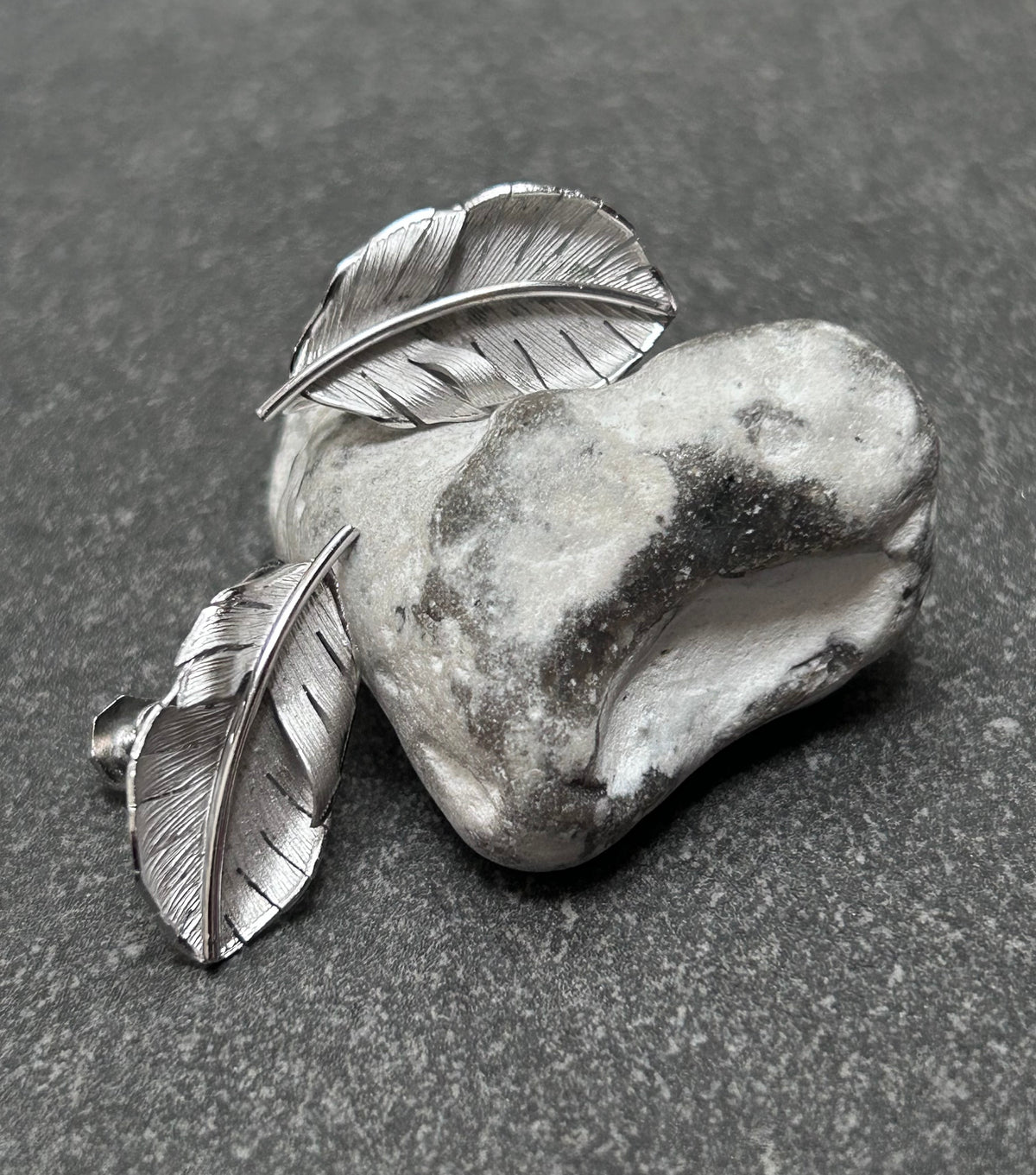 A beautiful pair of vintage screw on sterling silver feather earrings