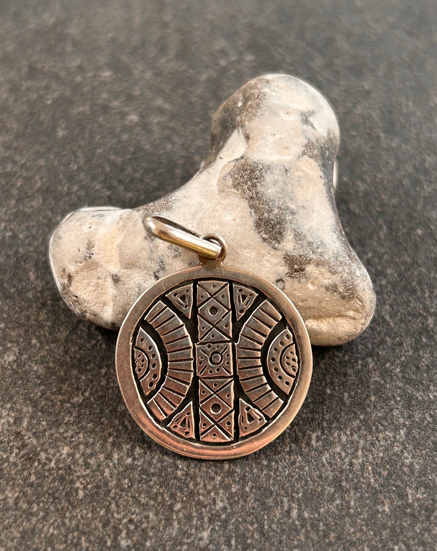 A beautifully crafted vintage sterling silver circular pendant