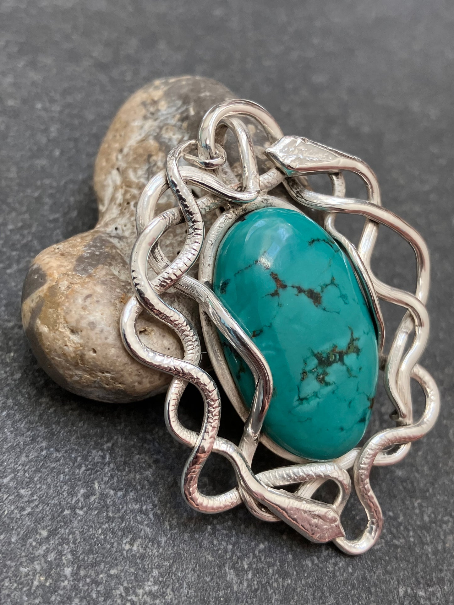 Artisan vintage sterling silver intertwining snake pendant with a piece of Turqurenite in the centre.