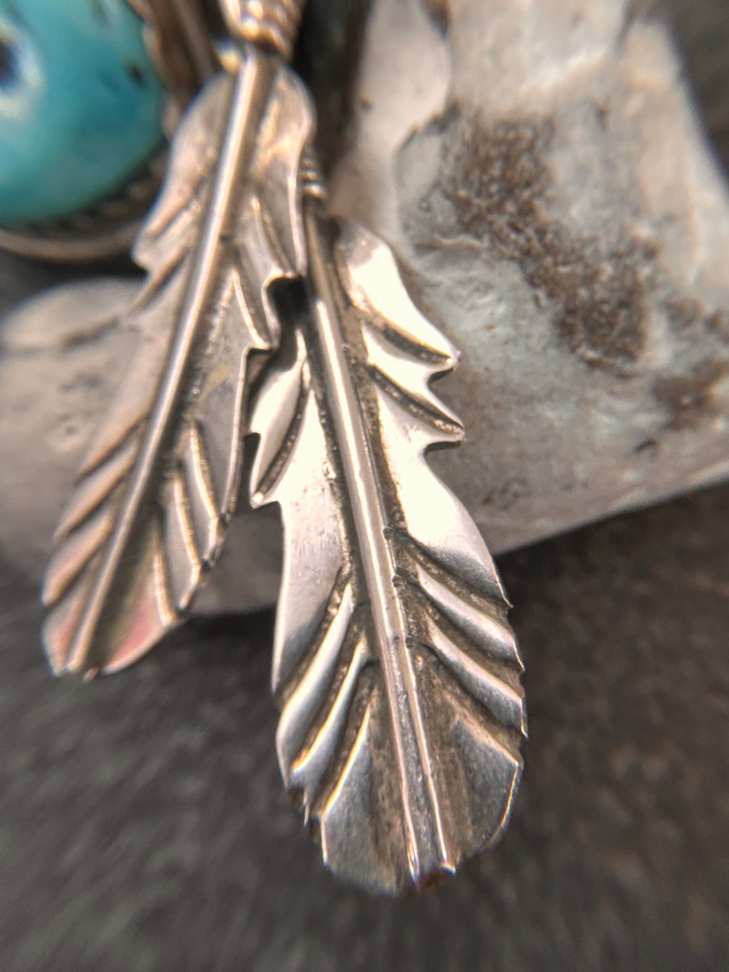 Beautiful vintage Native American sterling silver earrings featuring striking turquoise cabochons and feathers.