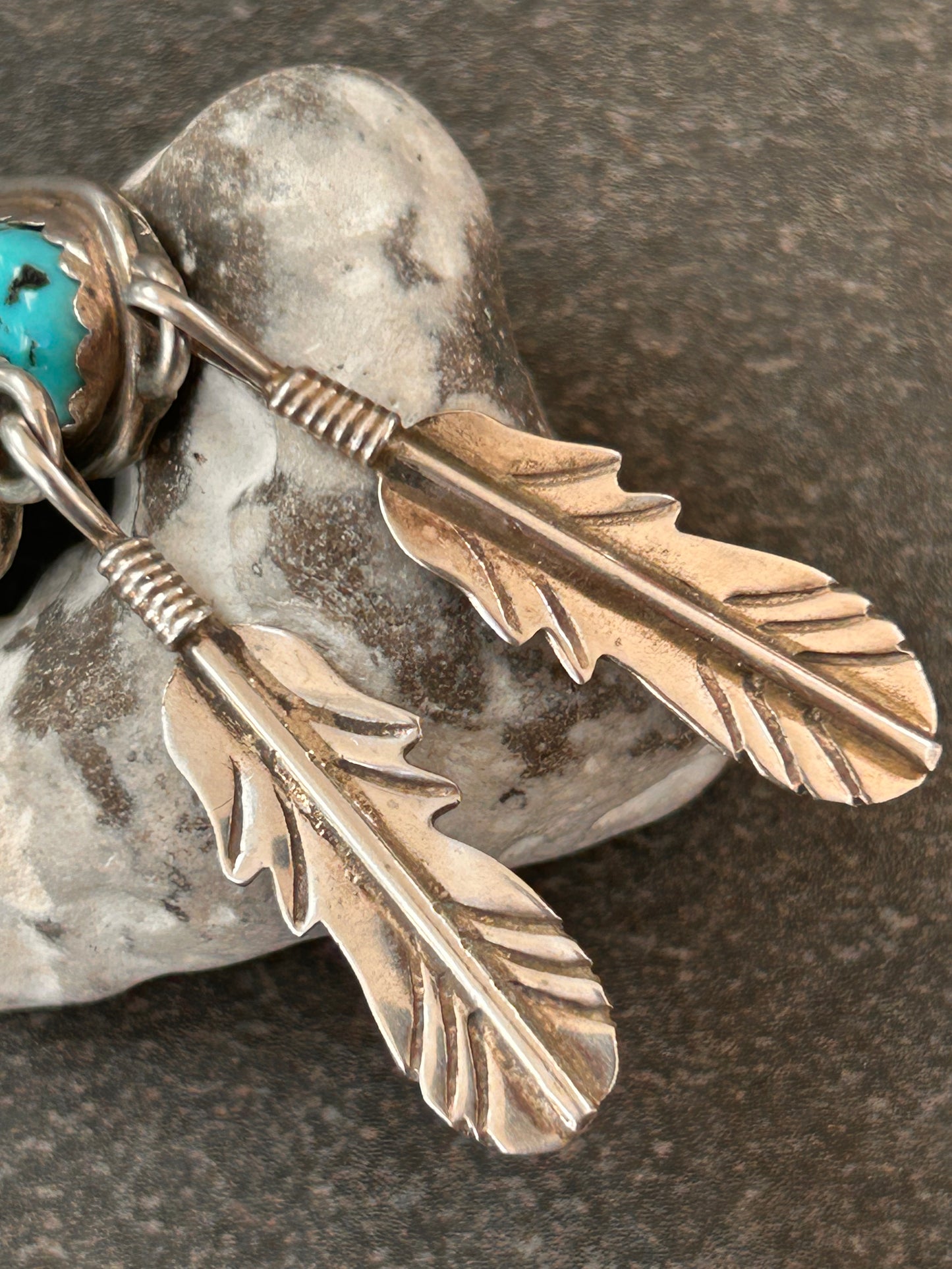 Beautiful vintage Native American sterling silver earrings featuring striking turquoise cabochons and feathers.