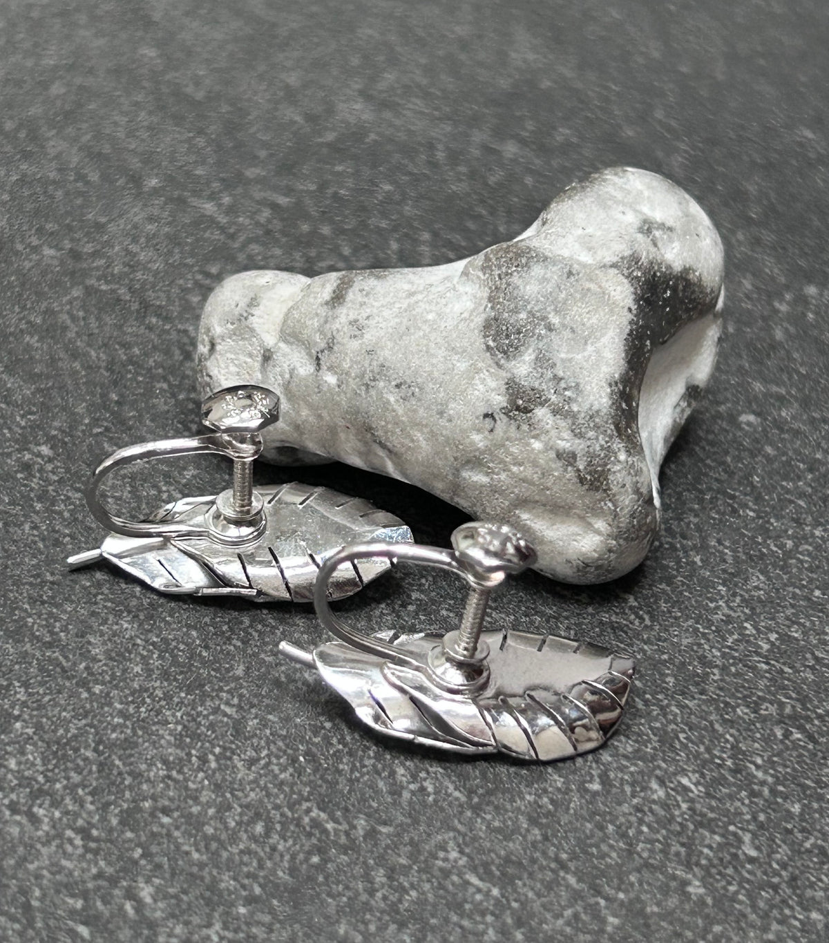 A beautiful pair of vintage screw on sterling silver feather earrings