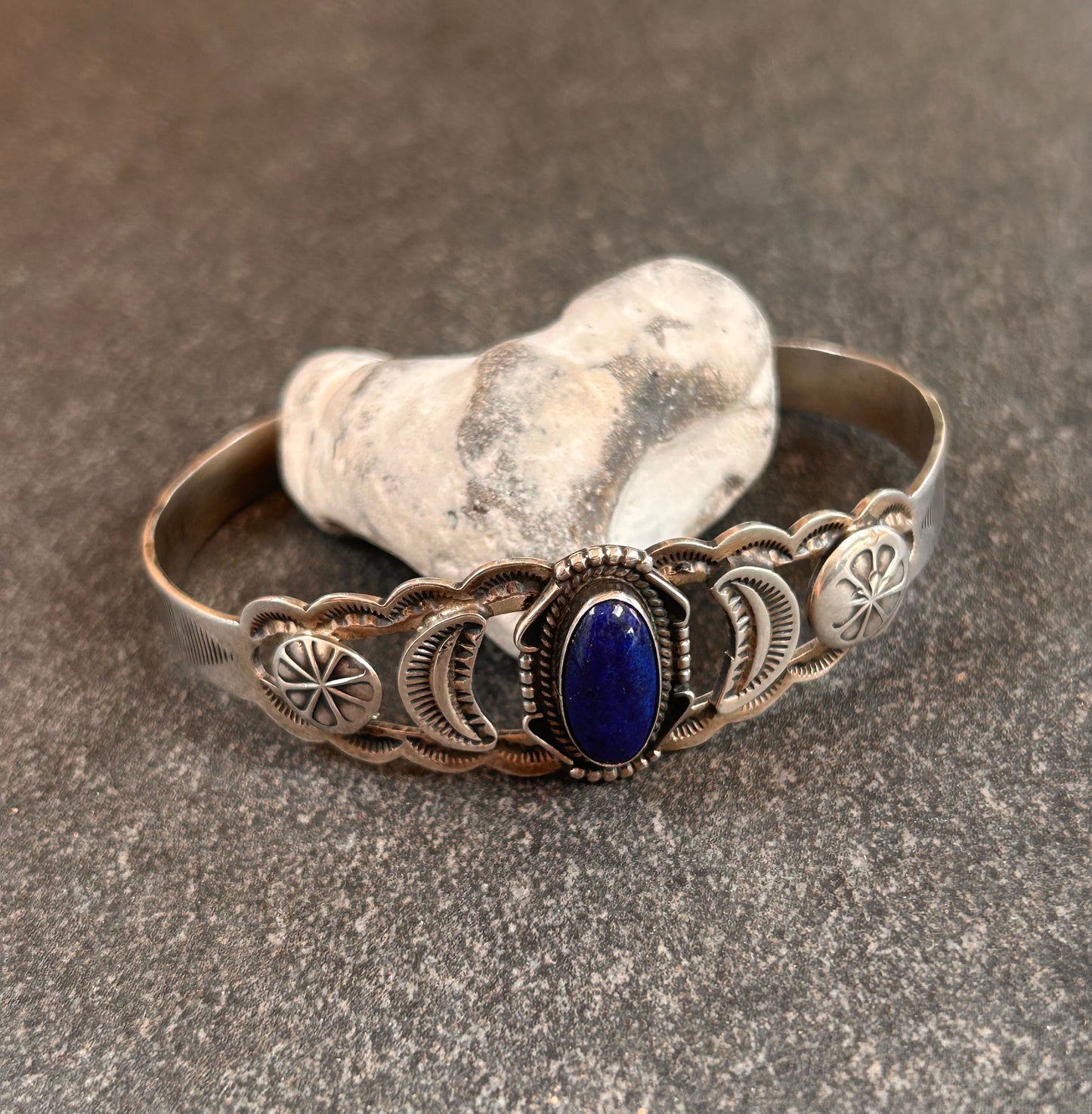 Vintage sterling silver Native American bangle featuring a striking central cabochon of lapis lazuli