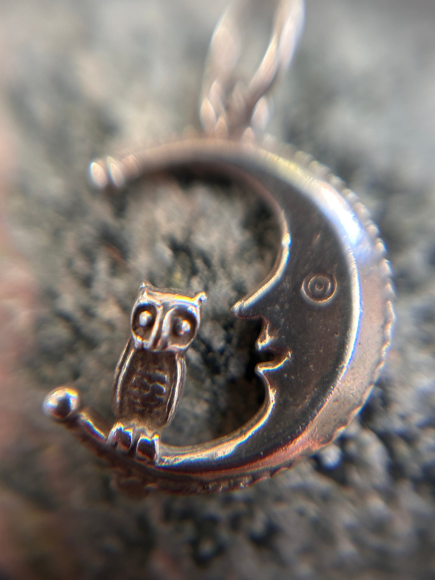 A beautifully whimsical vintage moon and owl pendant