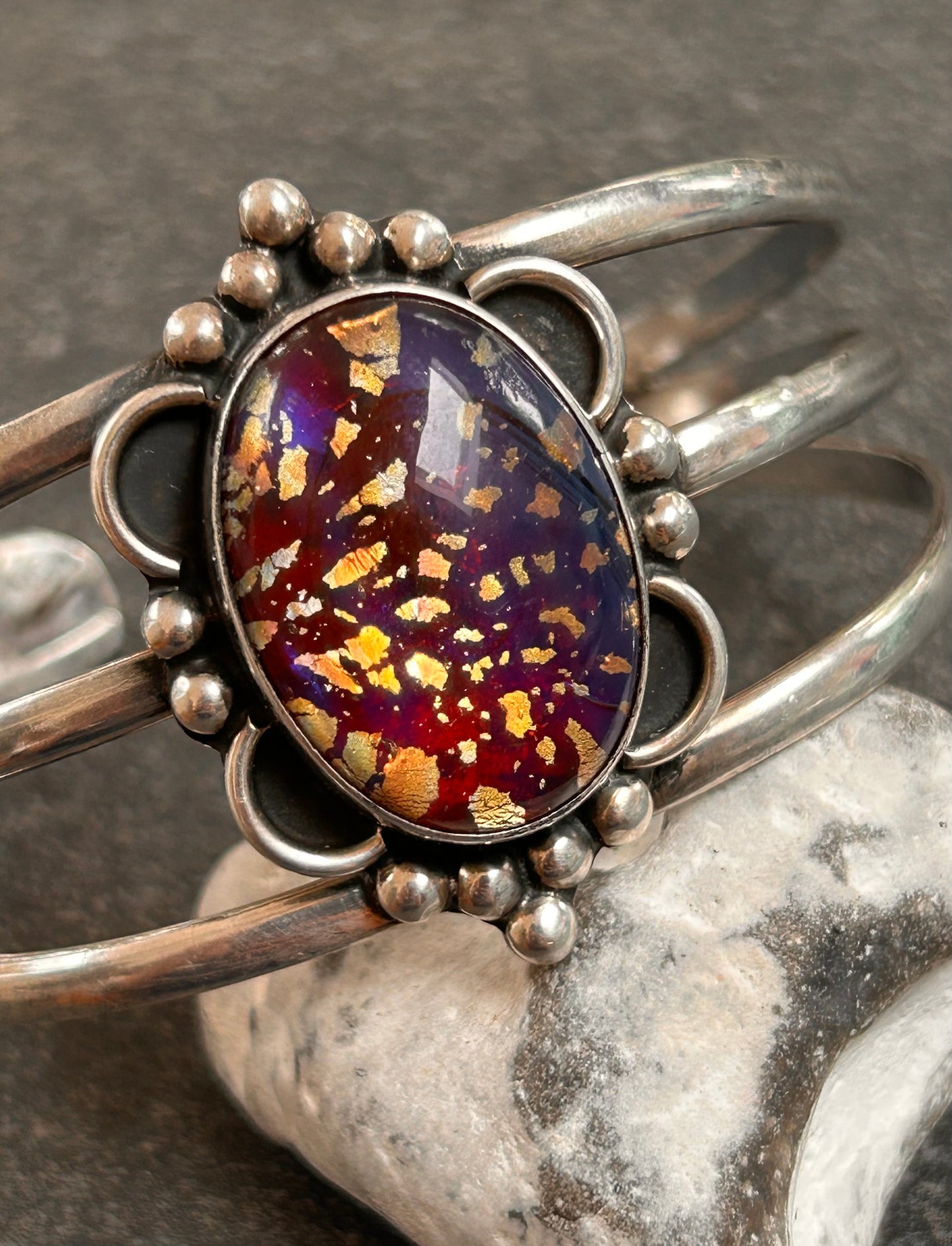 A striking vintage sterling silver bangle featuring a beautiful domed glass cabochon