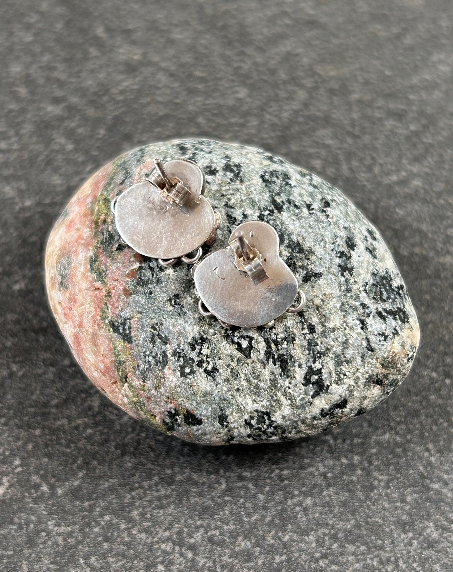 Beautiful sterling silver stud earrings set with cabochon-cut amethysts.