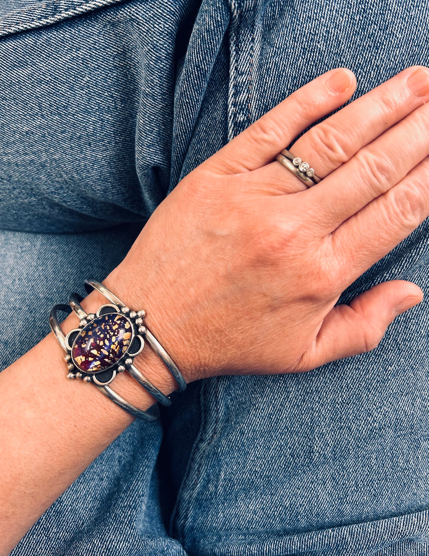 A striking vintage sterling silver bangle featuring a beautiful domed glass cabochon