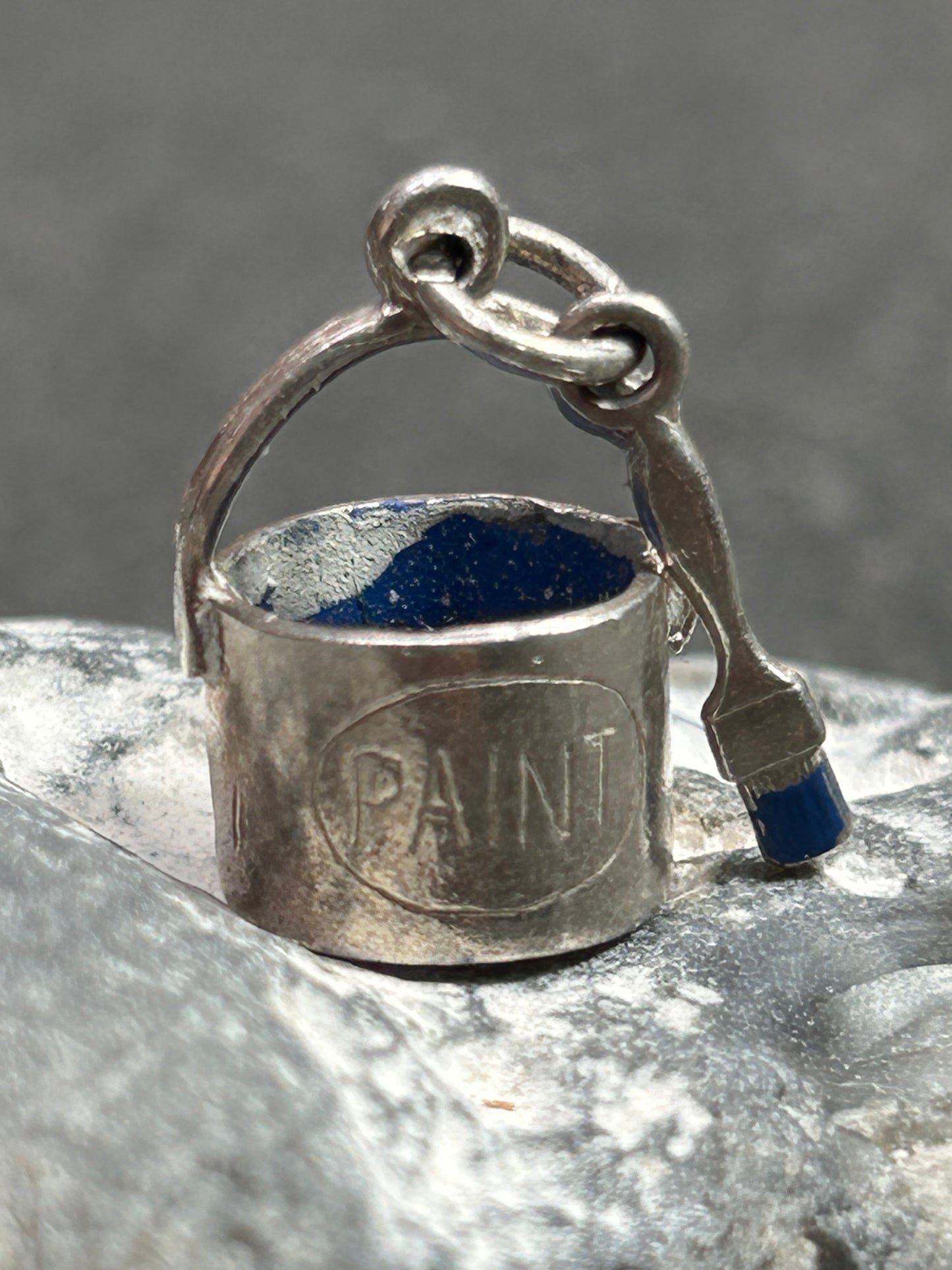 Pendant beautifully crafted in the shape of a painter’s paint pot and brush