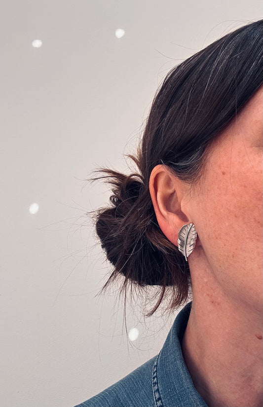 A beautiful pair of vintage screw on sterling silver feather earrings