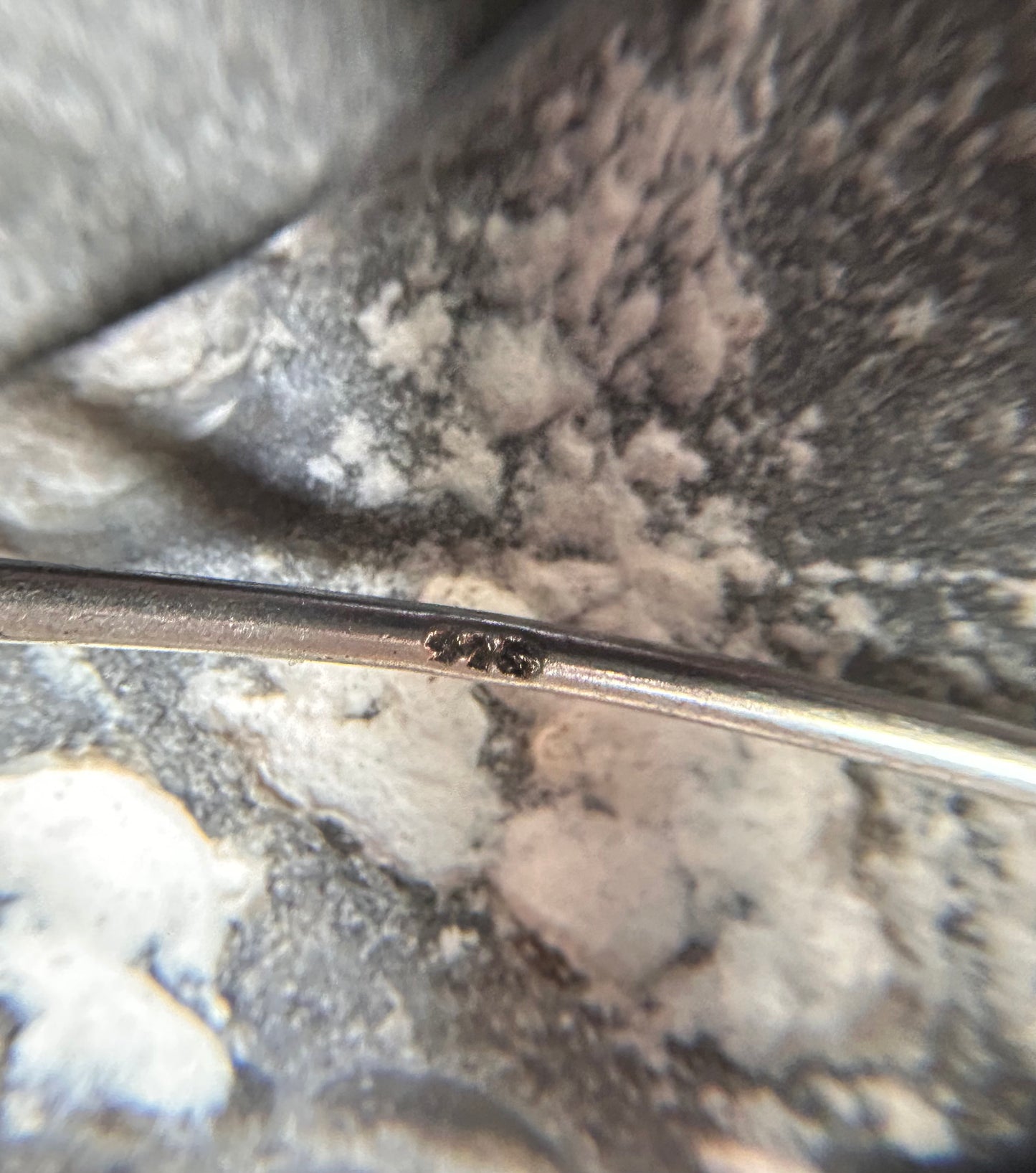 Delicate artisan bangle with two silver hearts.