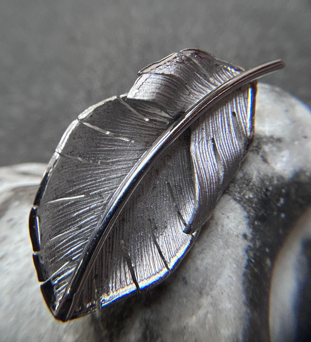 A beautiful pair of vintage screw on sterling silver feather earrings