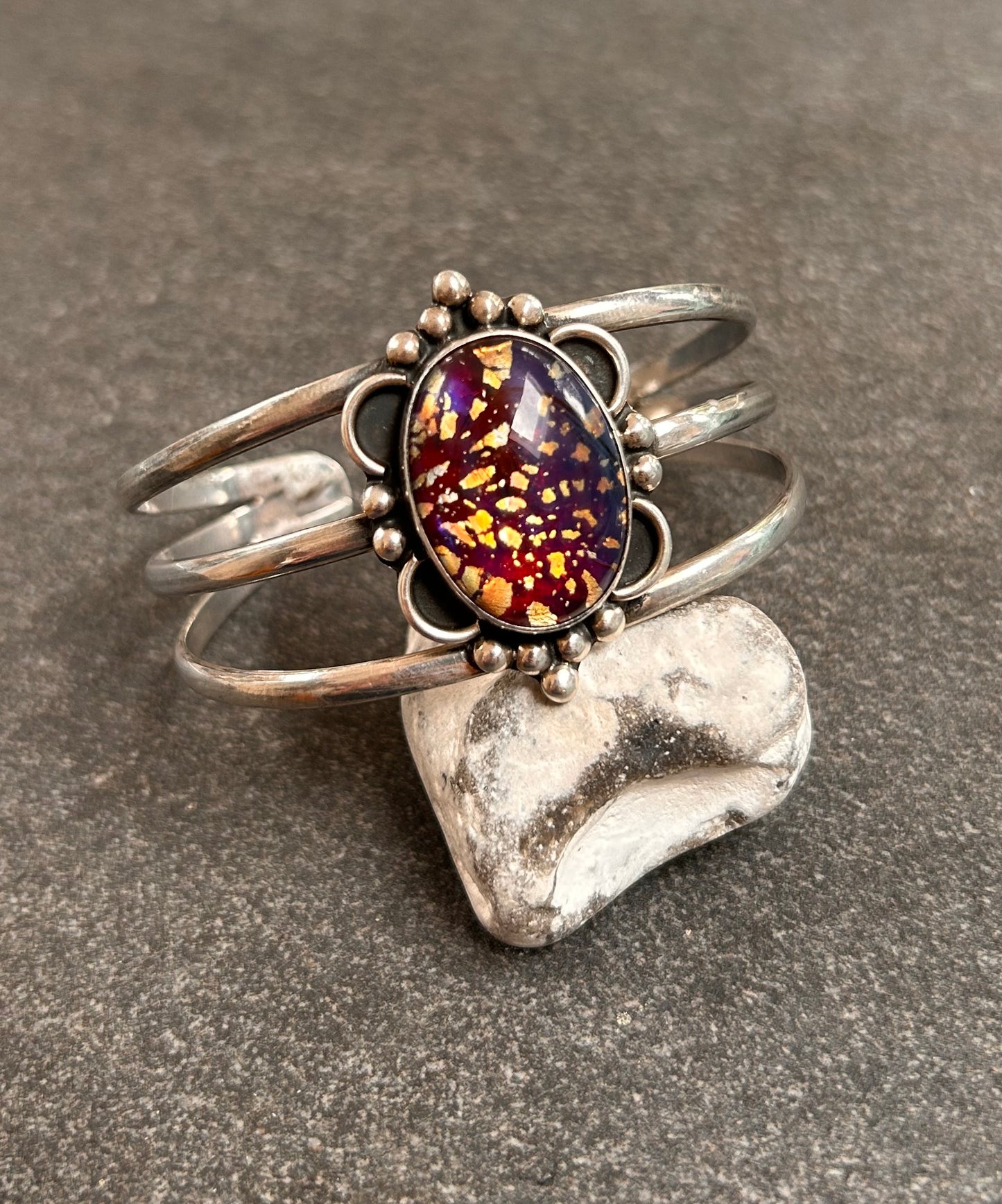 A striking vintage sterling silver bangle featuring a beautiful domed glass cabochon