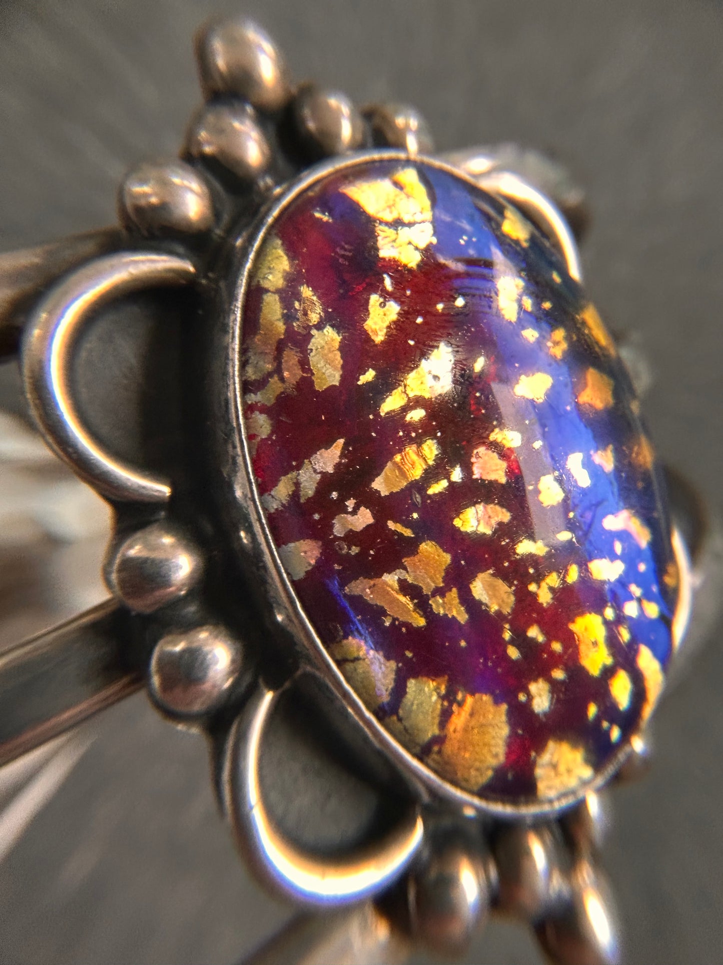 A striking vintage sterling silver bangle featuring a beautiful domed glass cabochon