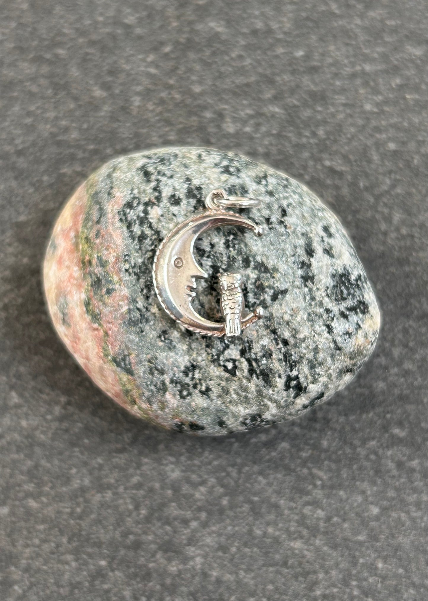 A beautifully whimsical vintage moon and owl pendant