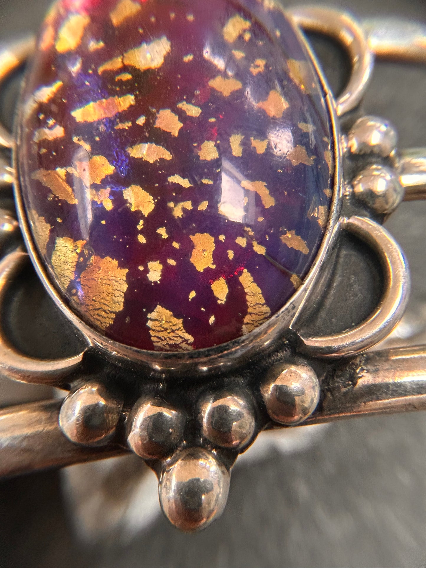 A striking vintage sterling silver bangle featuring a beautiful domed glass cabochon