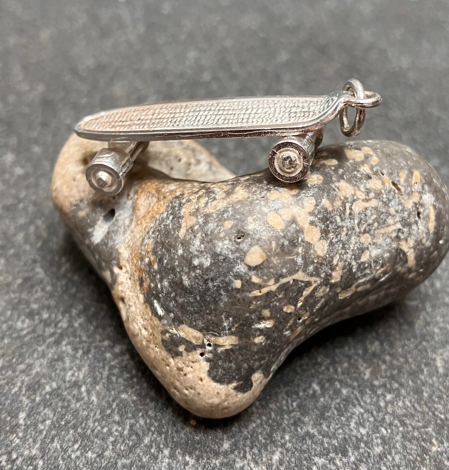 Vintage sterling silver skateboard pendant.