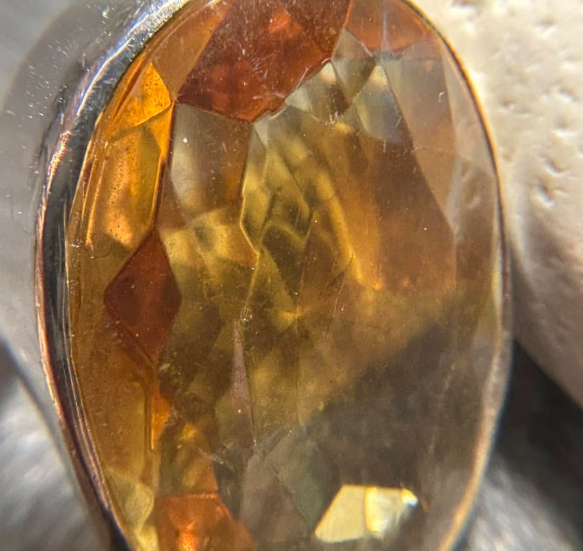 This absolutely stunning vintage cocktail ring features a beautifully cut piece of rich amber glass