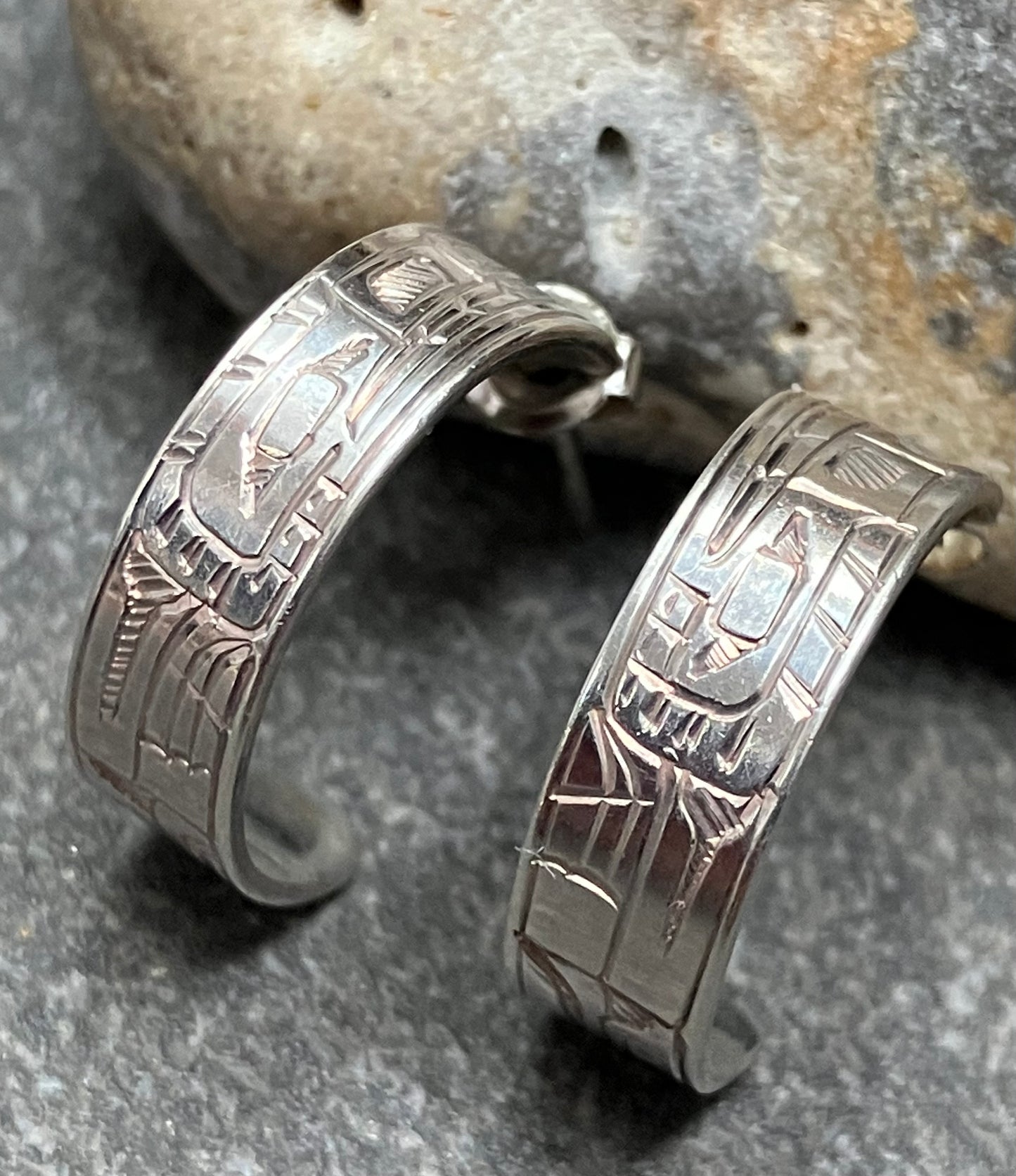 Vintage sterling silver hoops with all over intricate engraved pattern.