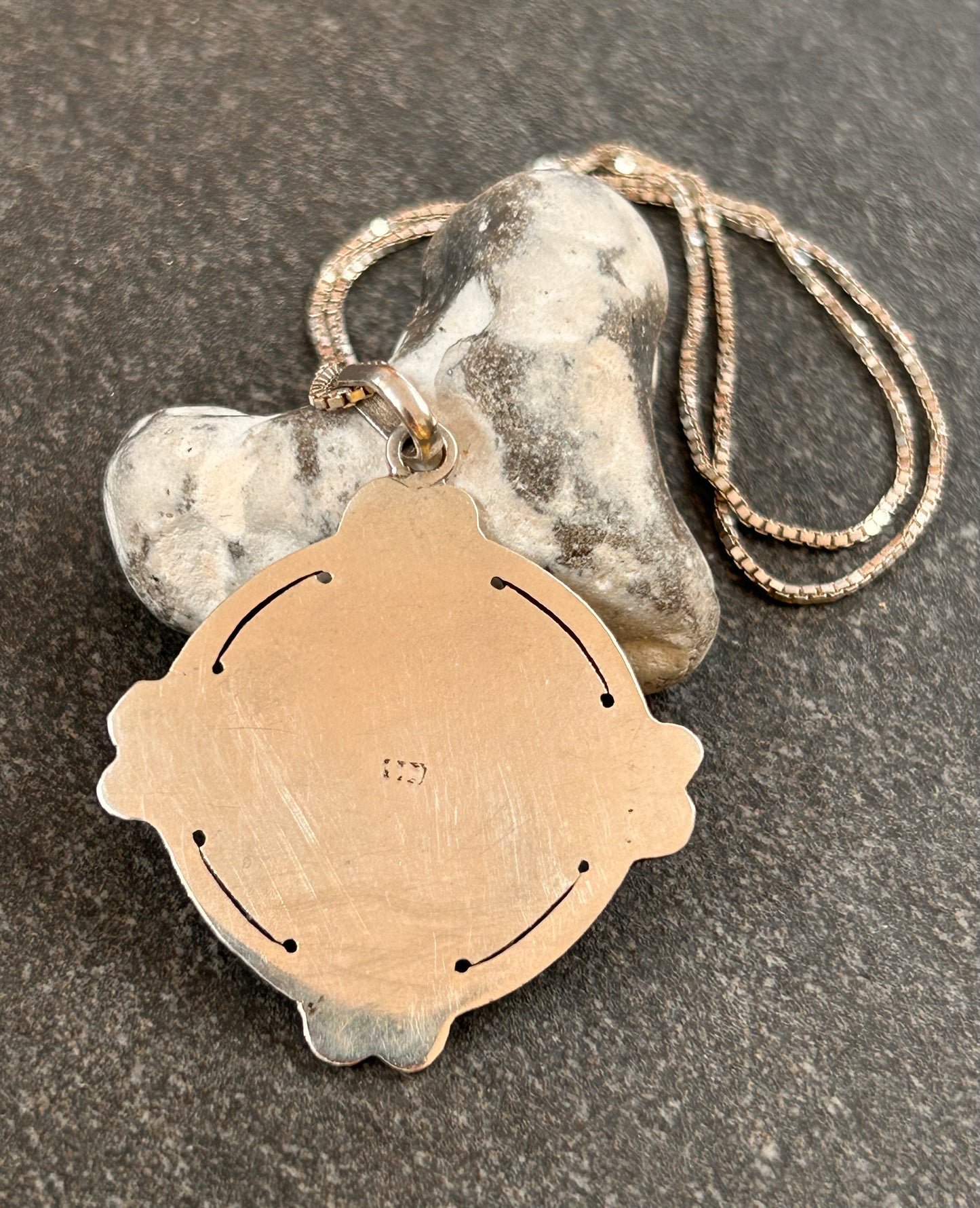 A captivating vintage sterling silver bohemian pendant featuring the ancient sun cross