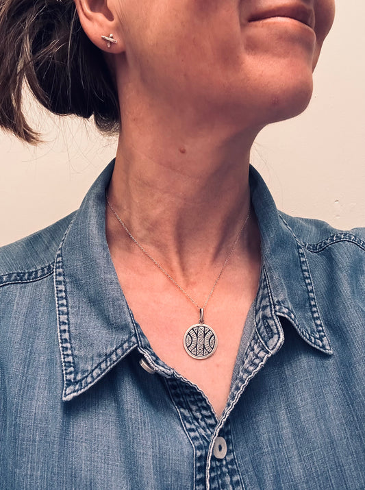 A beautifully crafted vintage sterling silver circular pendant