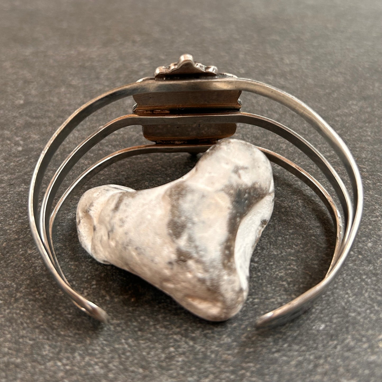 A striking vintage sterling silver bangle featuring a beautiful domed glass cabochon