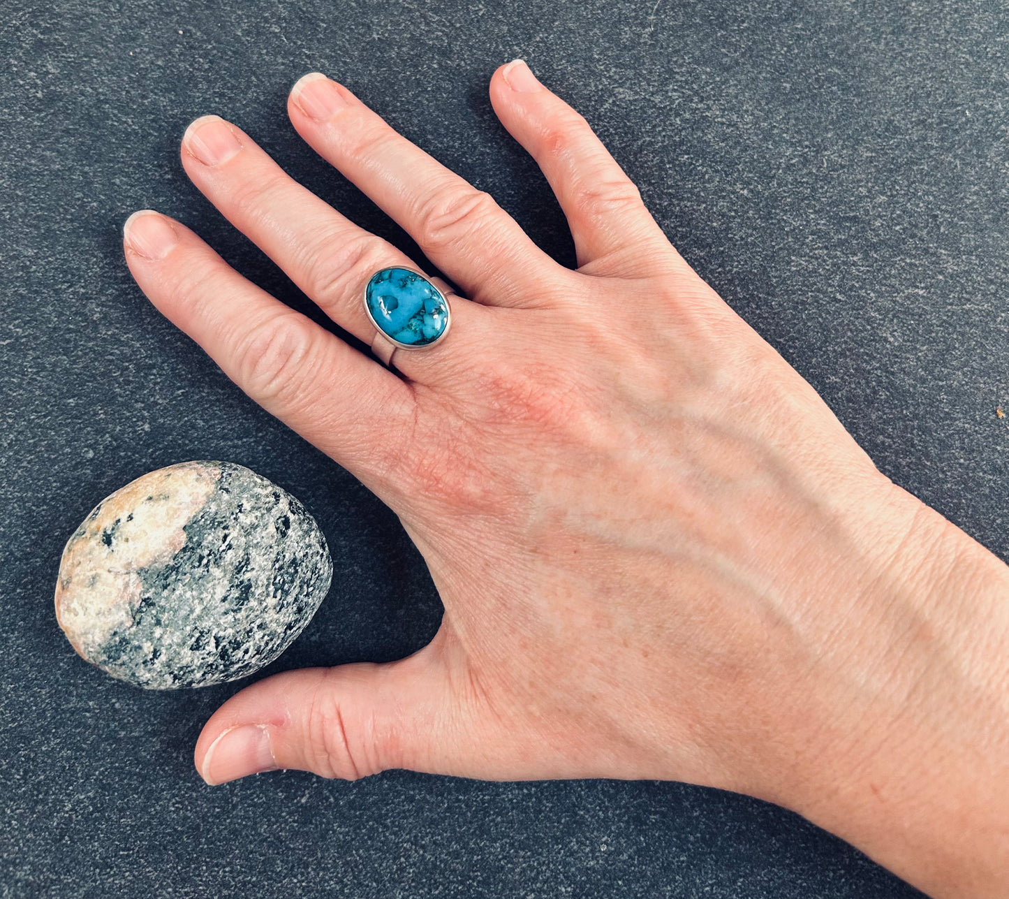 A beautiful vintage sterling silver ring featuring a striking turquoise stone - 1988