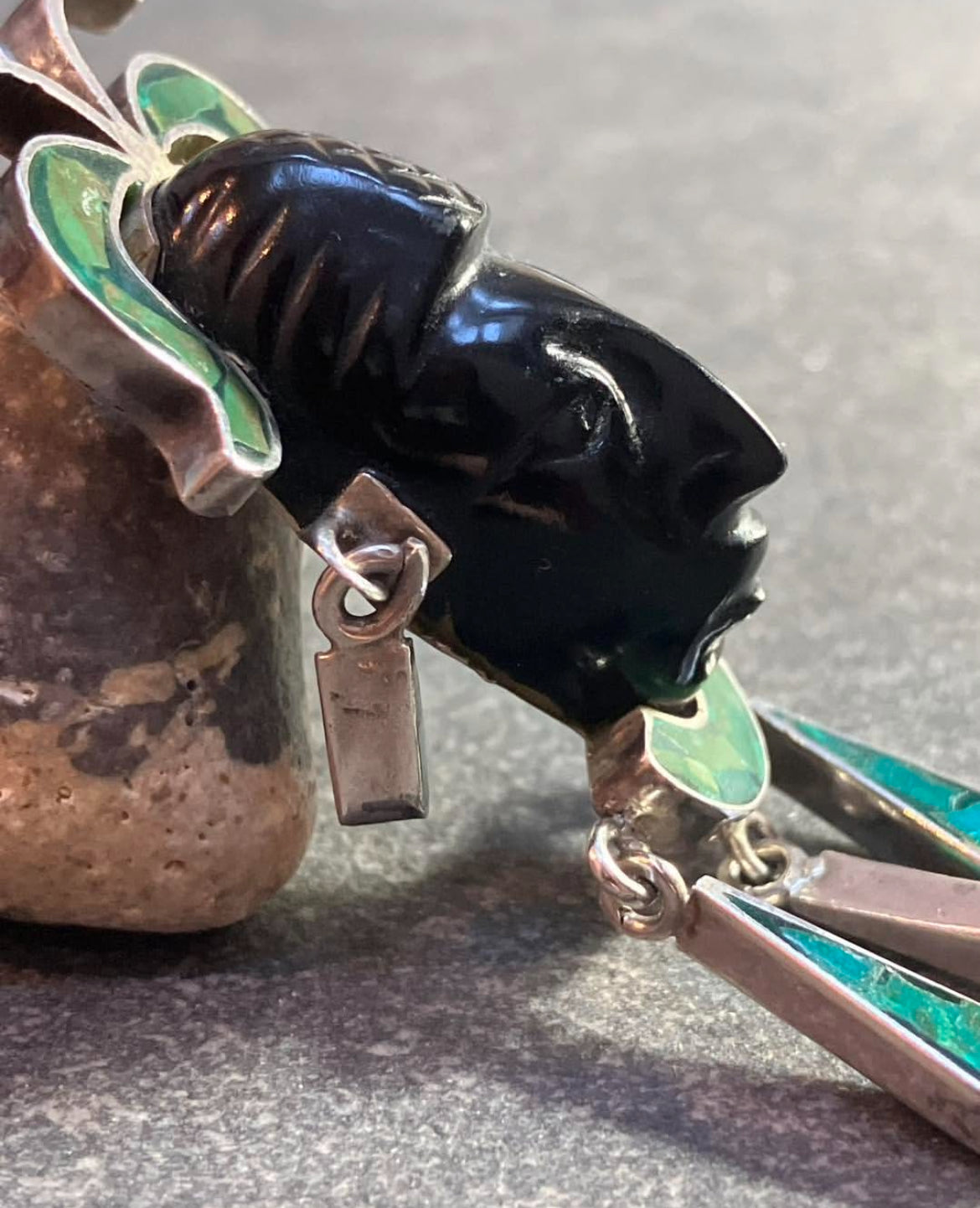 A striking vintage Mexican warrior face pendant crafted in sterling silver.