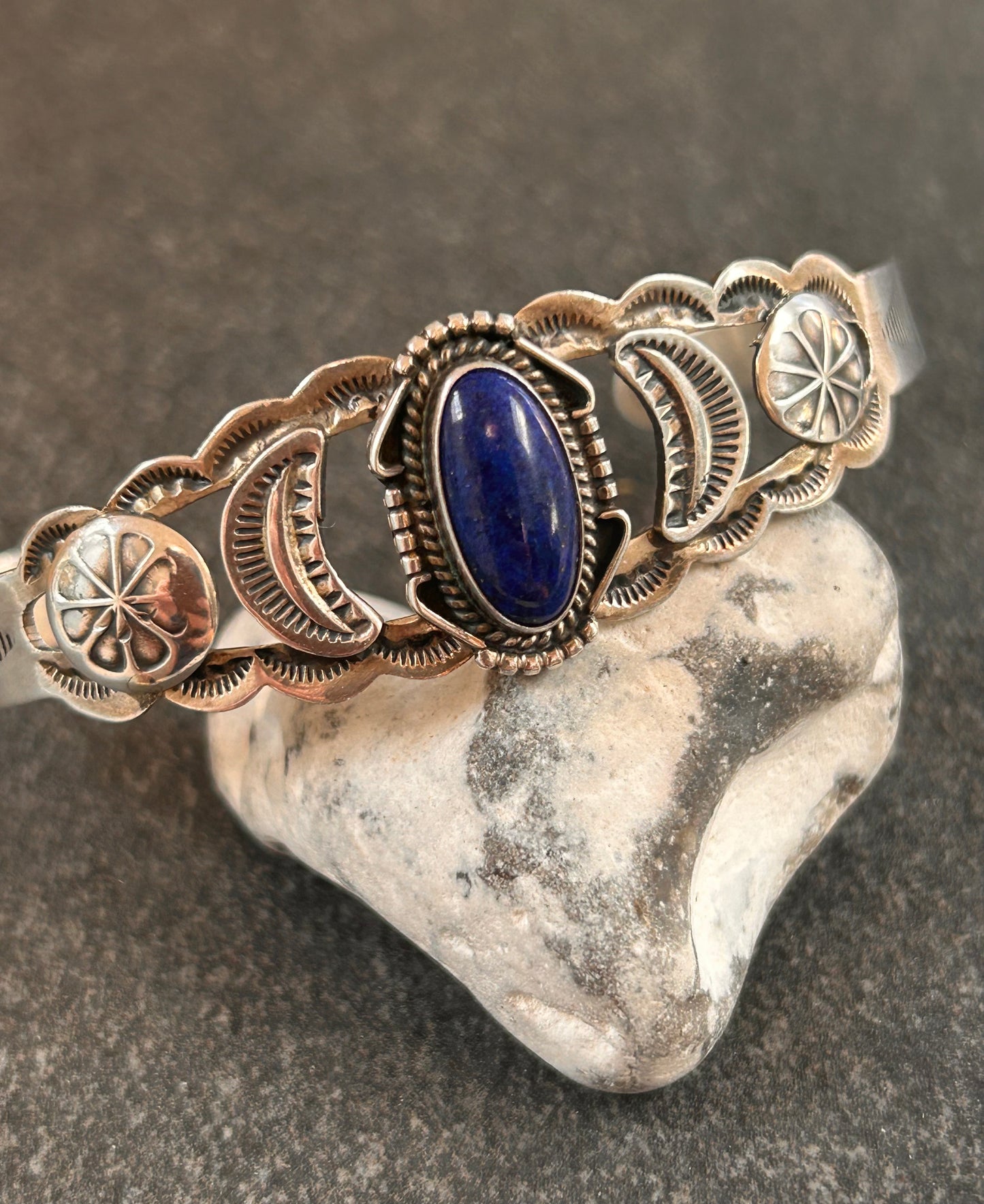 Vintage sterling silver Native American bangle featuring a striking central cabochon of lapis lazuli