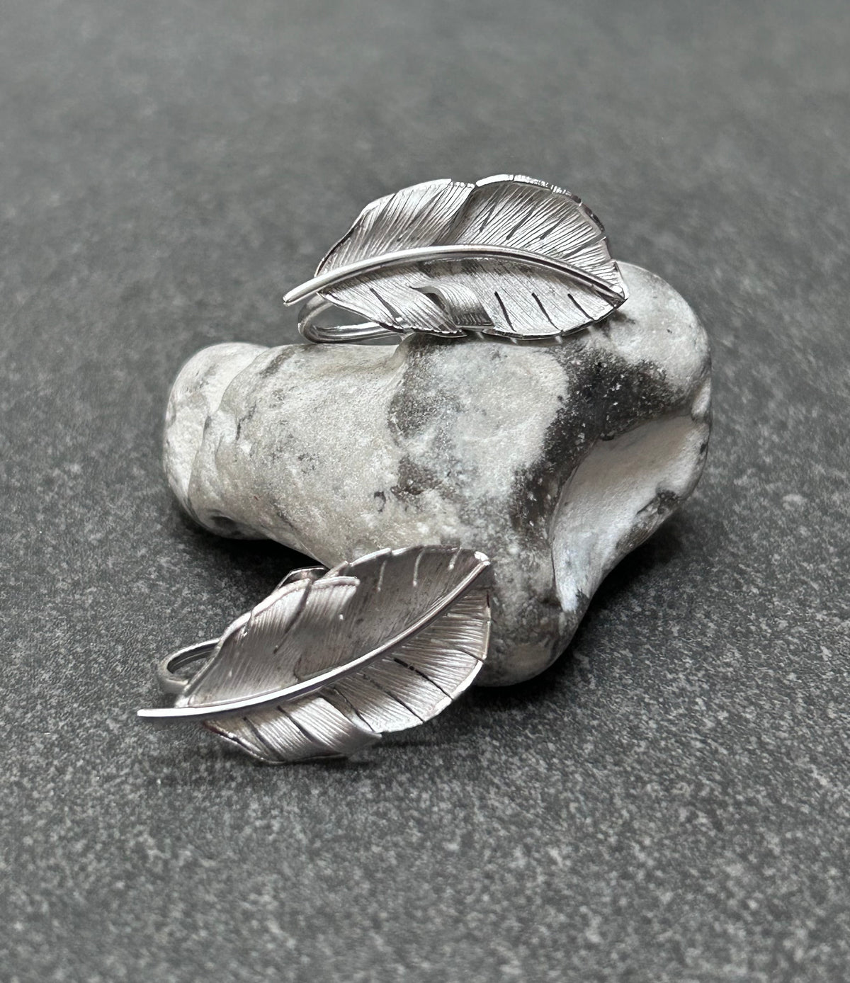 A beautiful pair of vintage screw on sterling silver feather earrings
