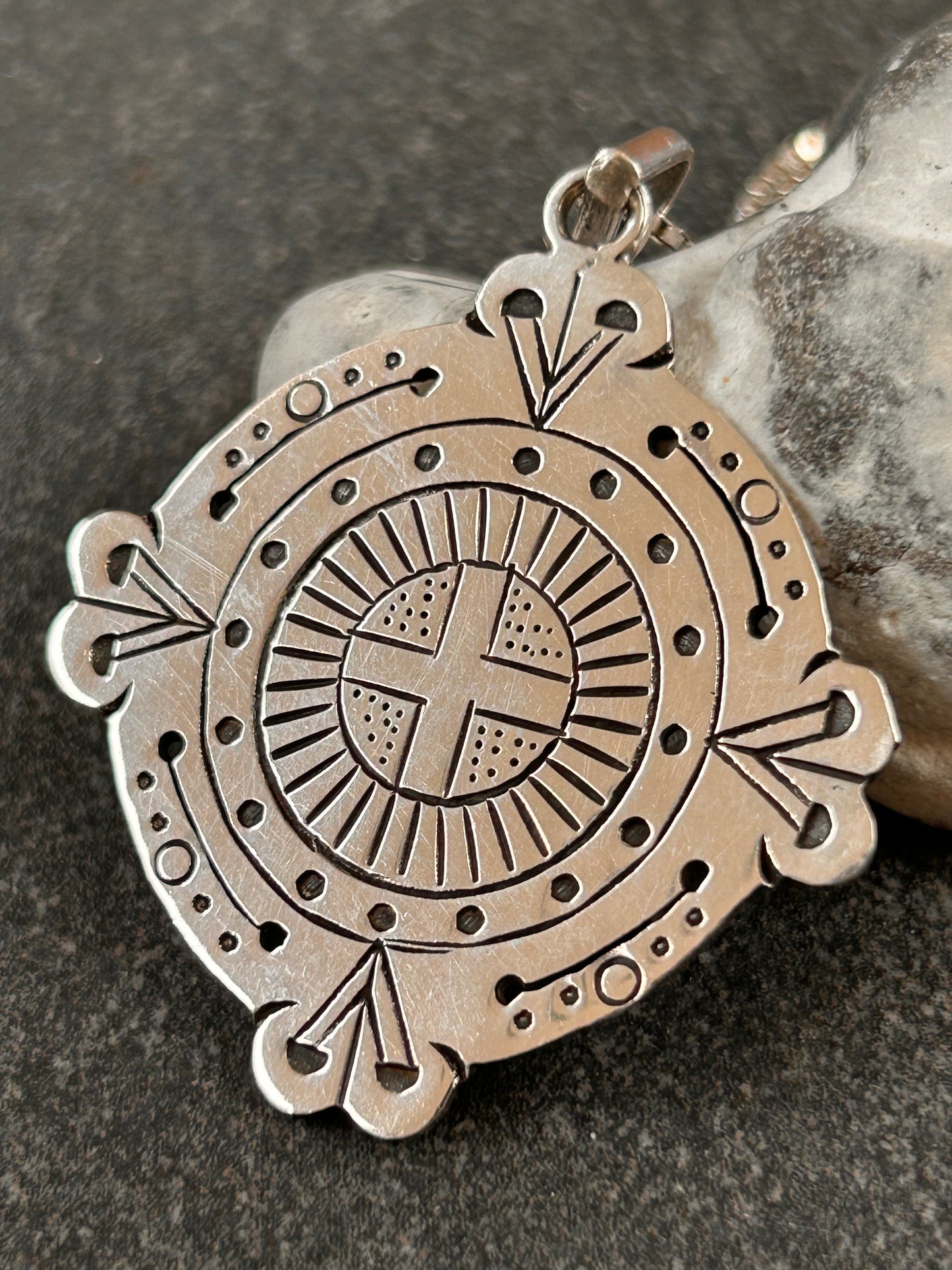 A captivating vintage sterling silver bohemian pendant featuring the ancient sun cross