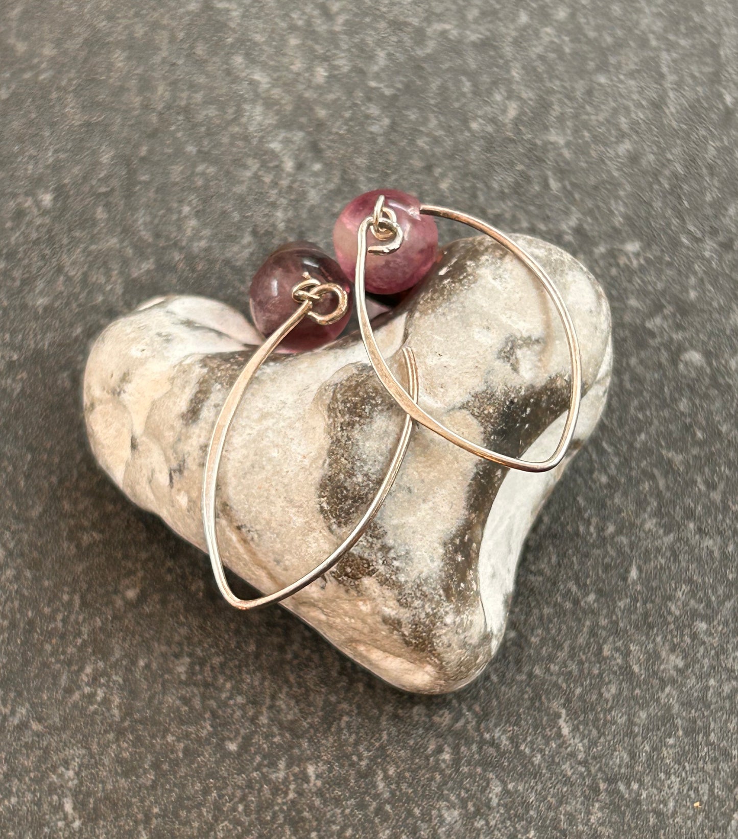 Simple and elegant, these sterling silver drop earrings feature rich amethyst beads